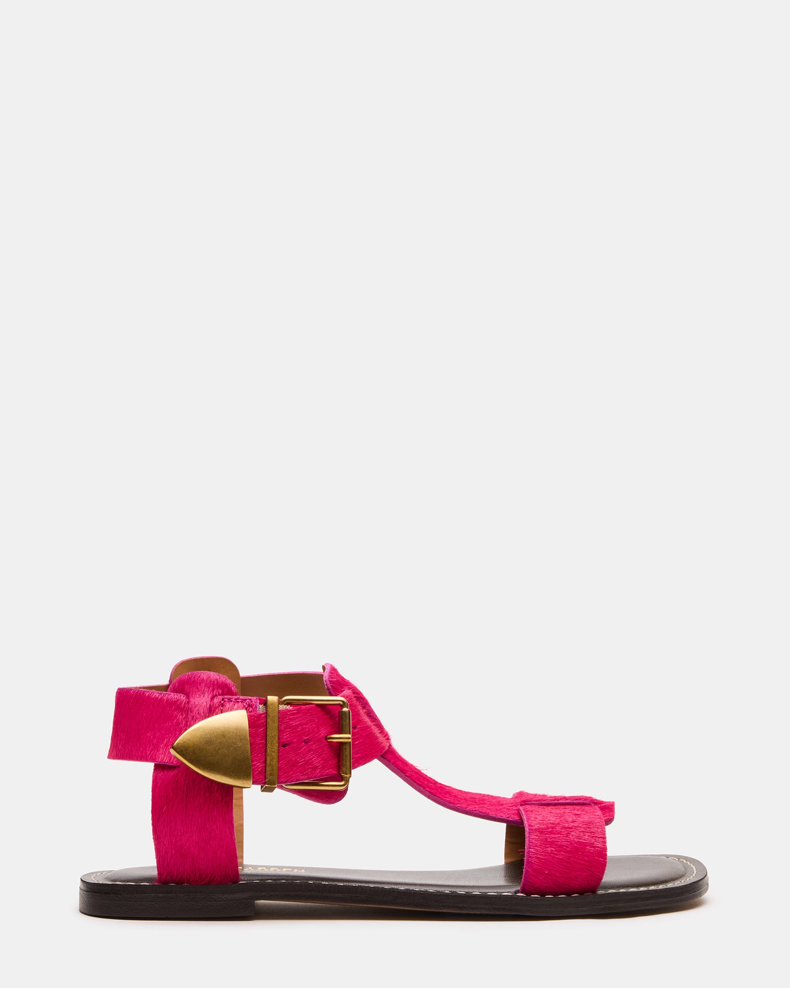 Hot pink leather flat sandals with ankle strap on a model's feet, perfect for summer outings