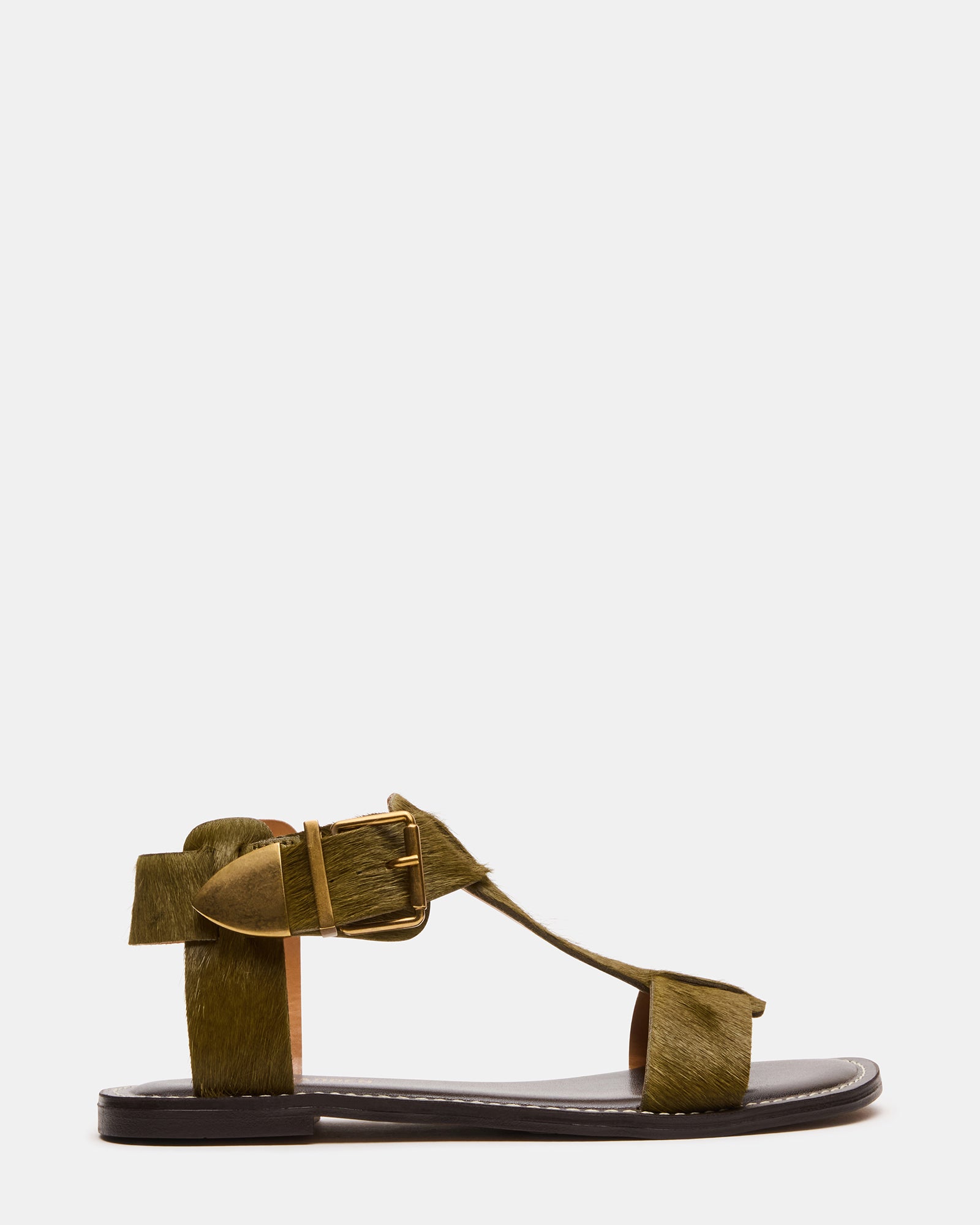 Top-down image of olive BRAZINN flat sandals on a rustic wood surface.