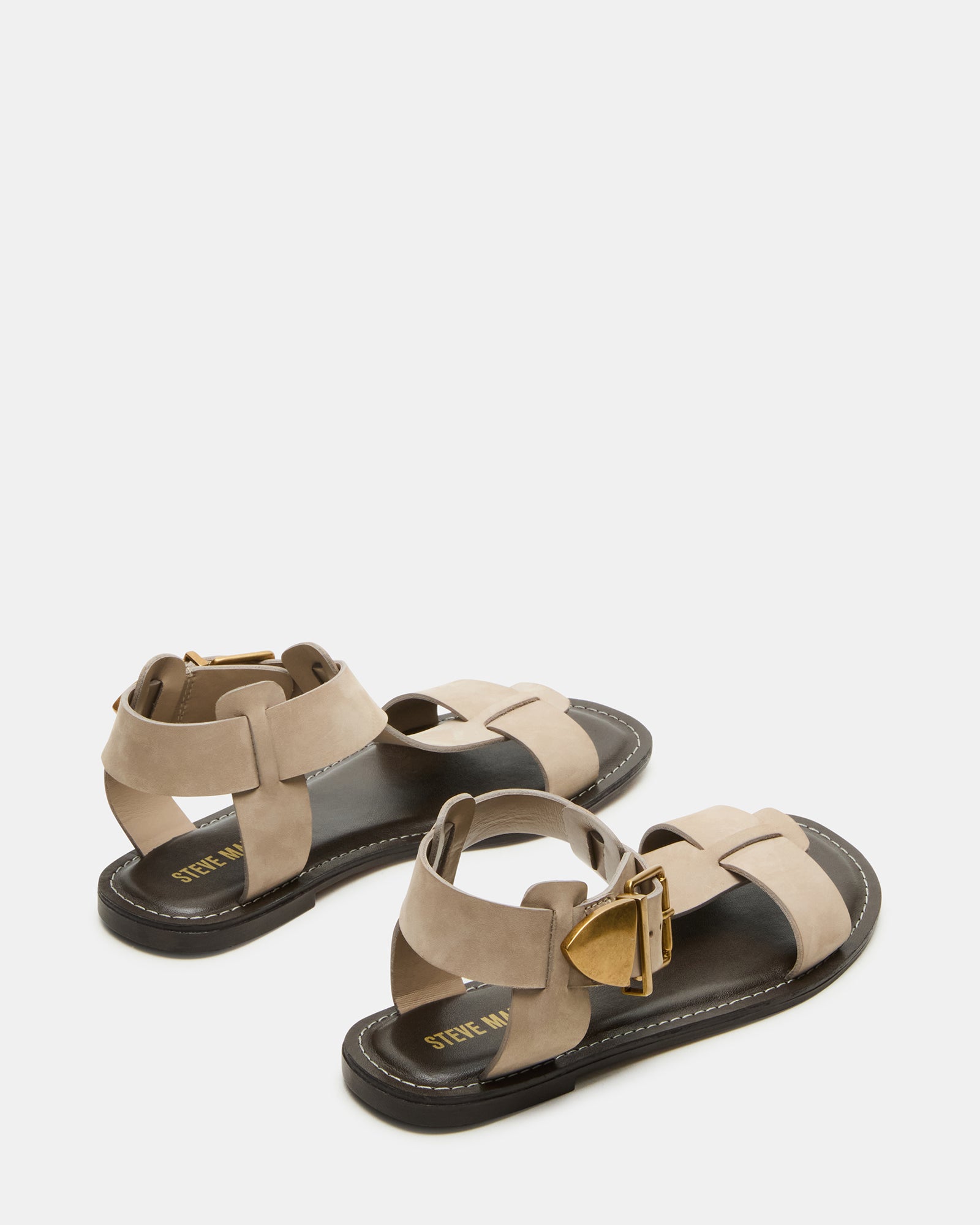 Close-up of the leather upper and synthetic sole of the flat sandals