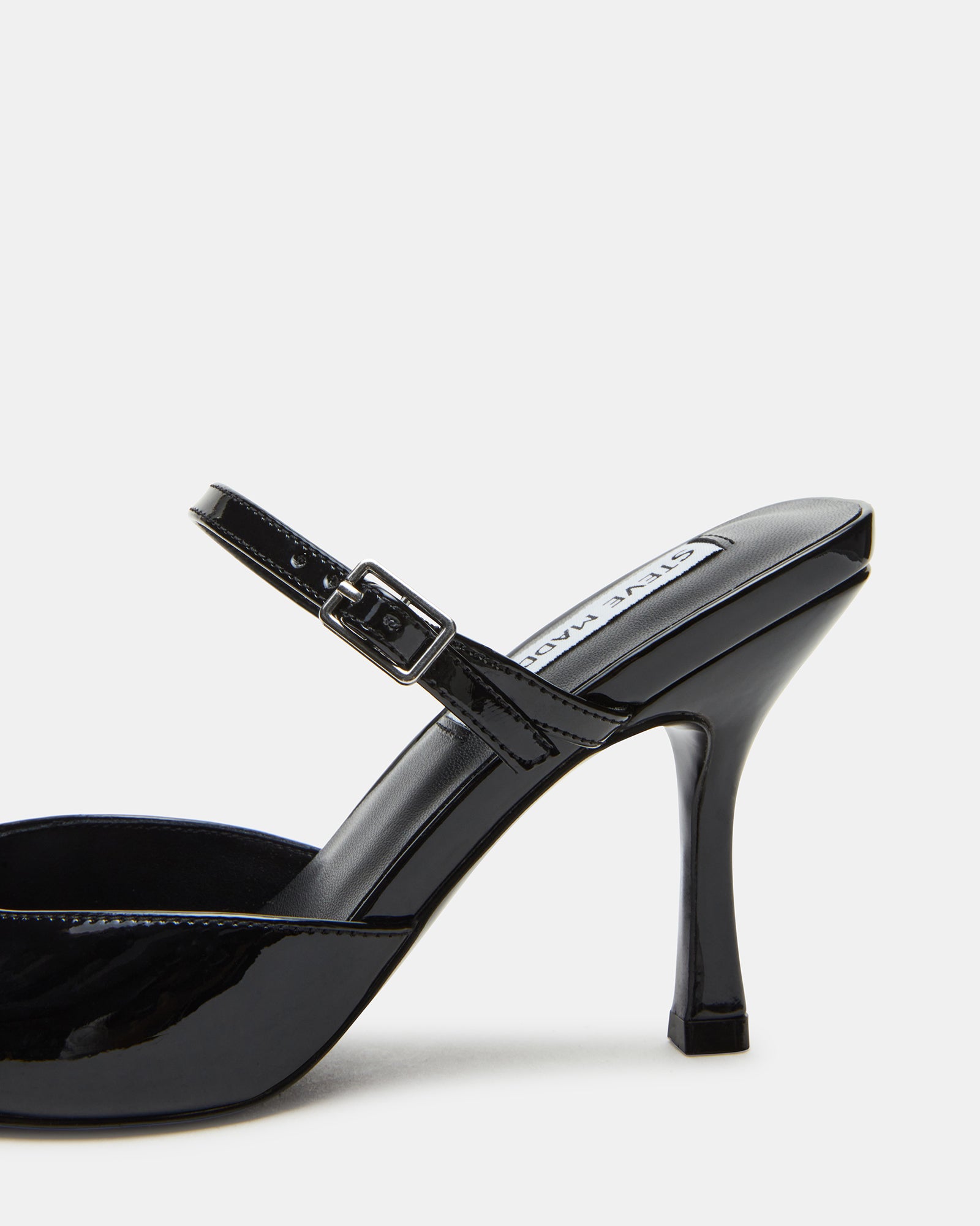 Side view of Brecki Luxe black patent mules showcasing the pointed toe.