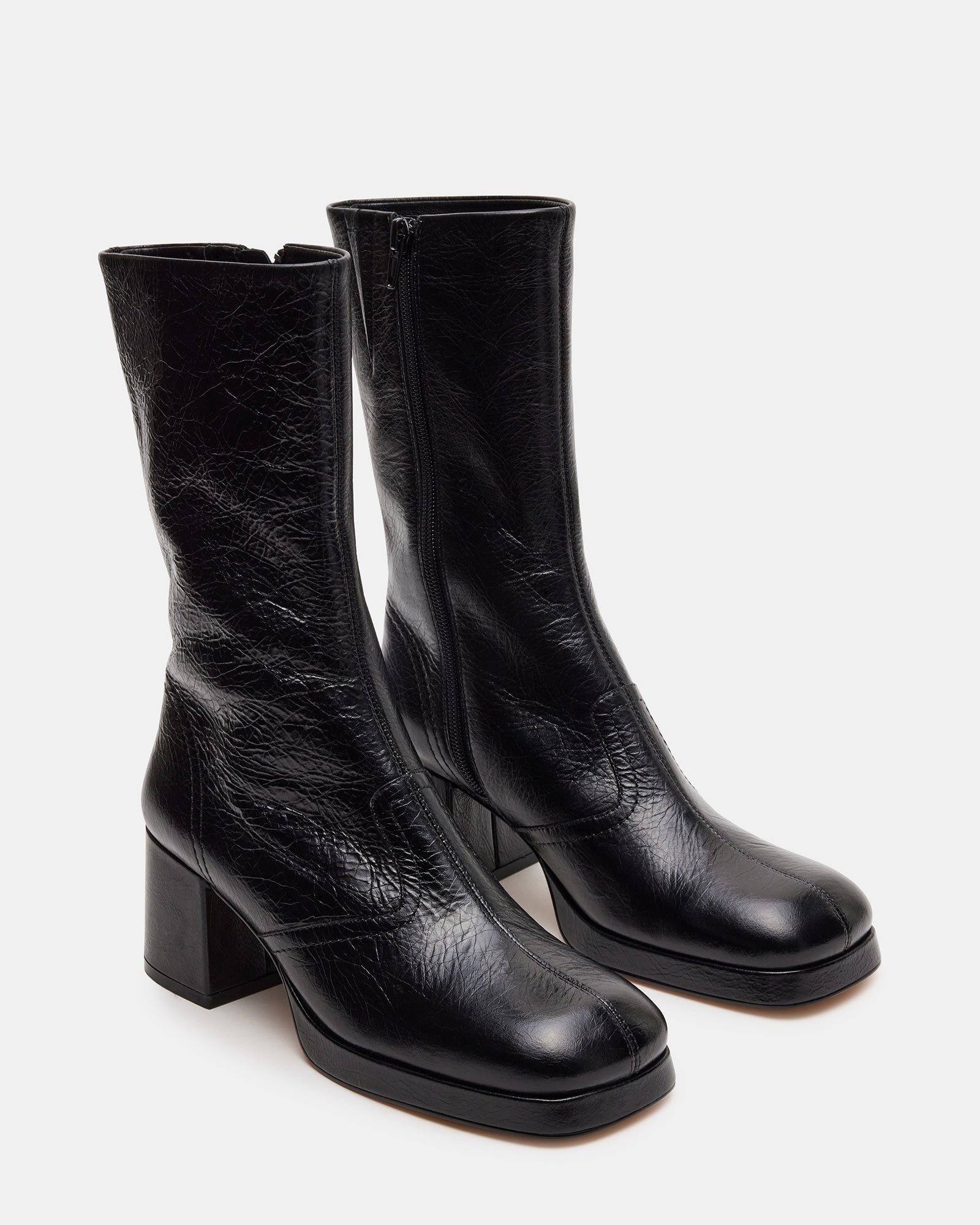 Close-up of the heel and toe detail of black leather ankle booties