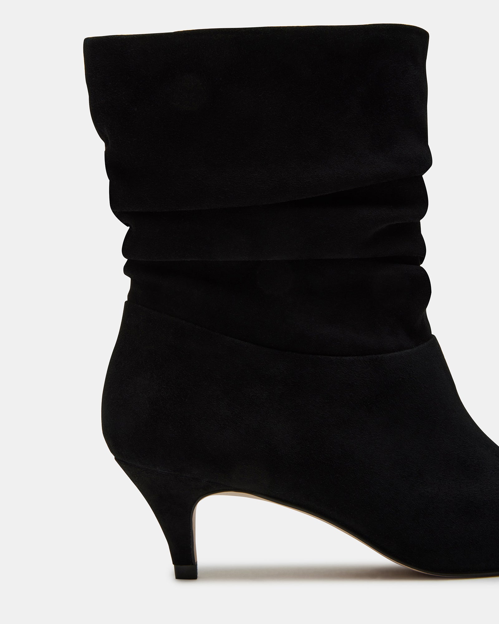 Side view of black suede kitten heel boots showcasing pointed toe and scrunched detailing