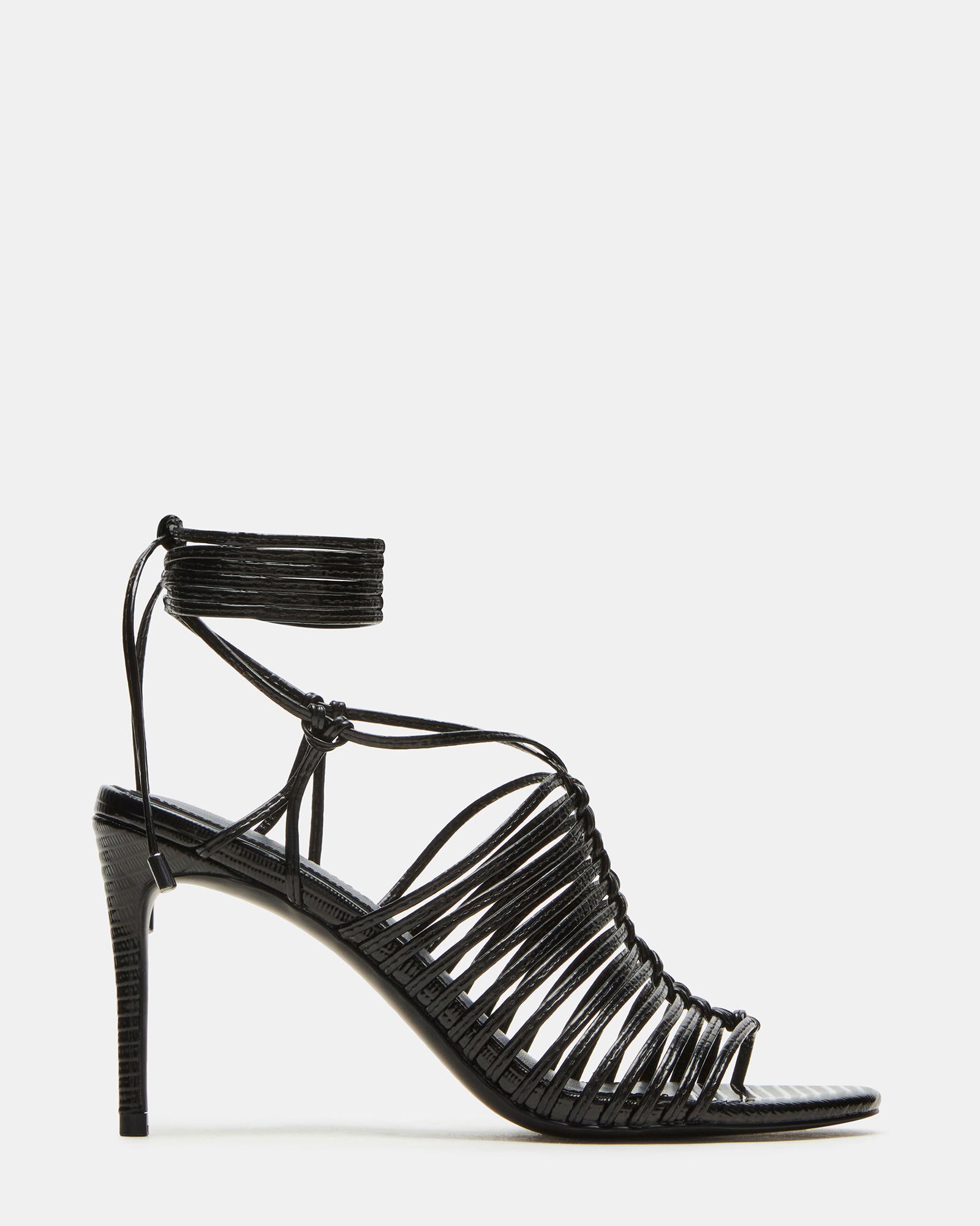 Side view of black stiletto heels with leg ties, styled for evening wear.