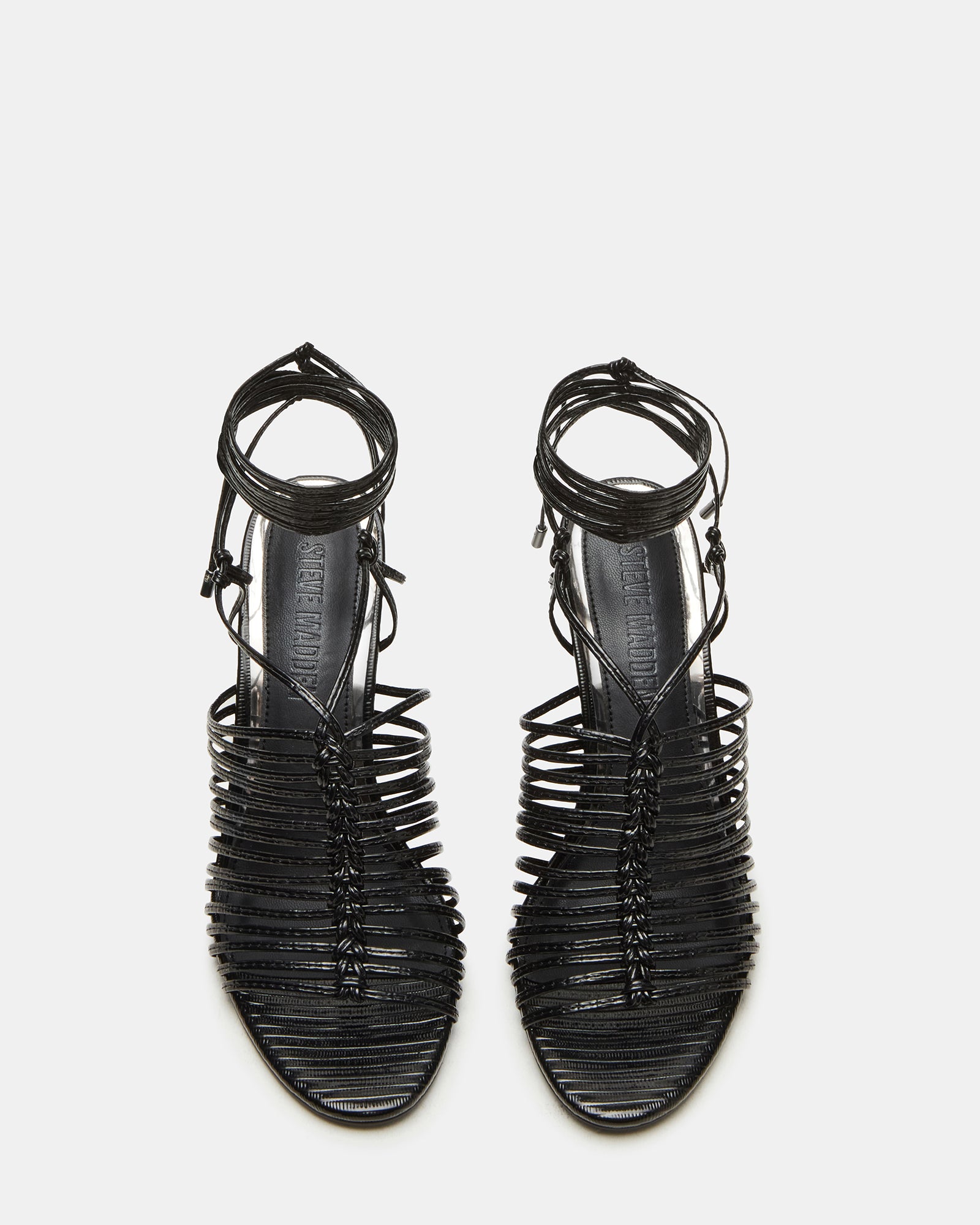 Side view of black stiletto heels with leg ties, styled for evening wear.