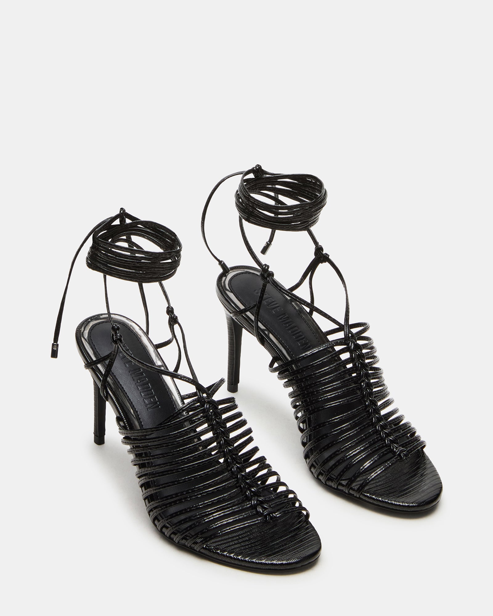 Close-up of Bristowe heel straps and synthetic finish, ideal for fashion-forward outfits.