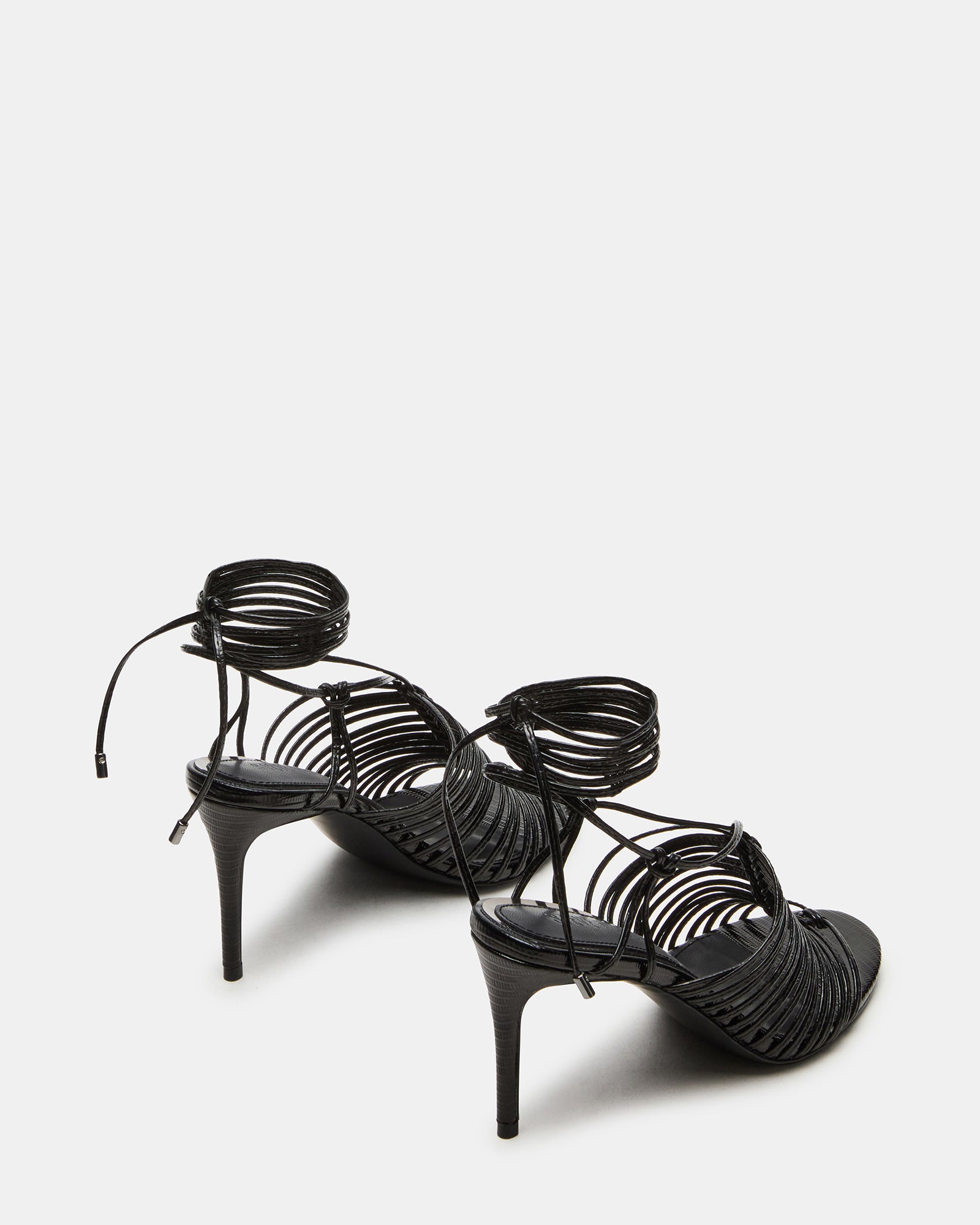 Close-up of Bristowe heel straps and synthetic finish, ideal for fashion-forward outfits.