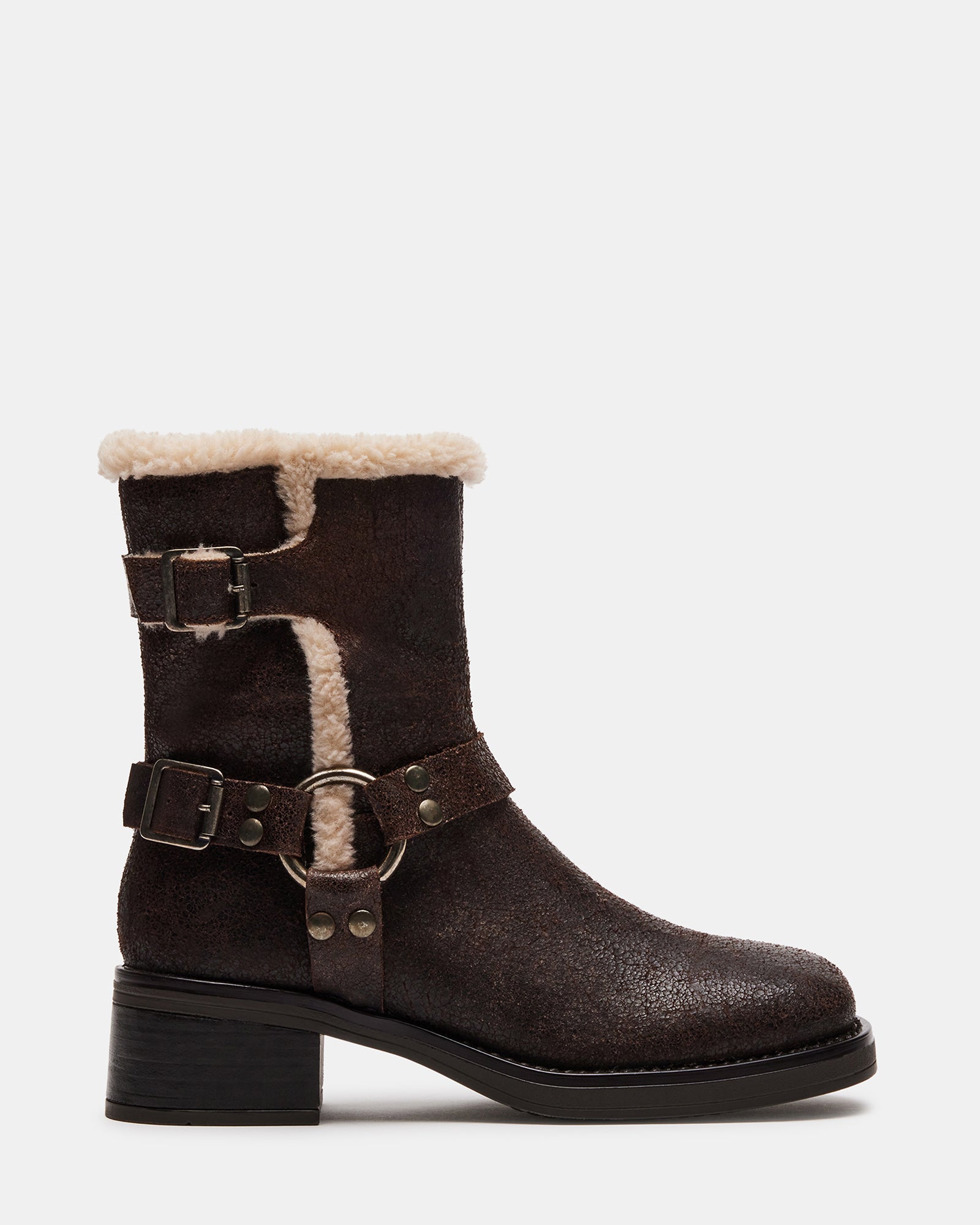 Side view of brown moto boots with faux shearling lining and block heel