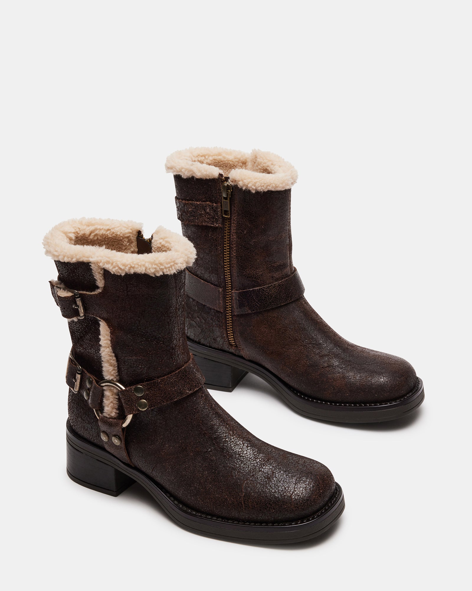 Close-up of adjustable buckled straps and distressed leather texture