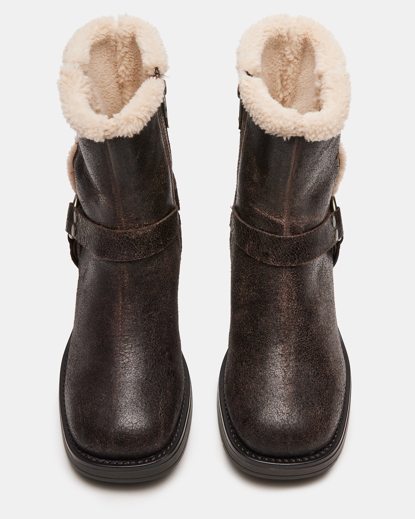 Side view of brown moto boots with faux shearling lining and block heel