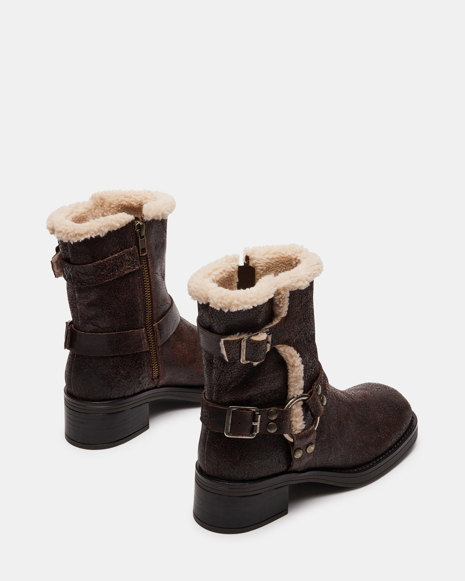 Close-up of adjustable buckled straps and distressed leather texture