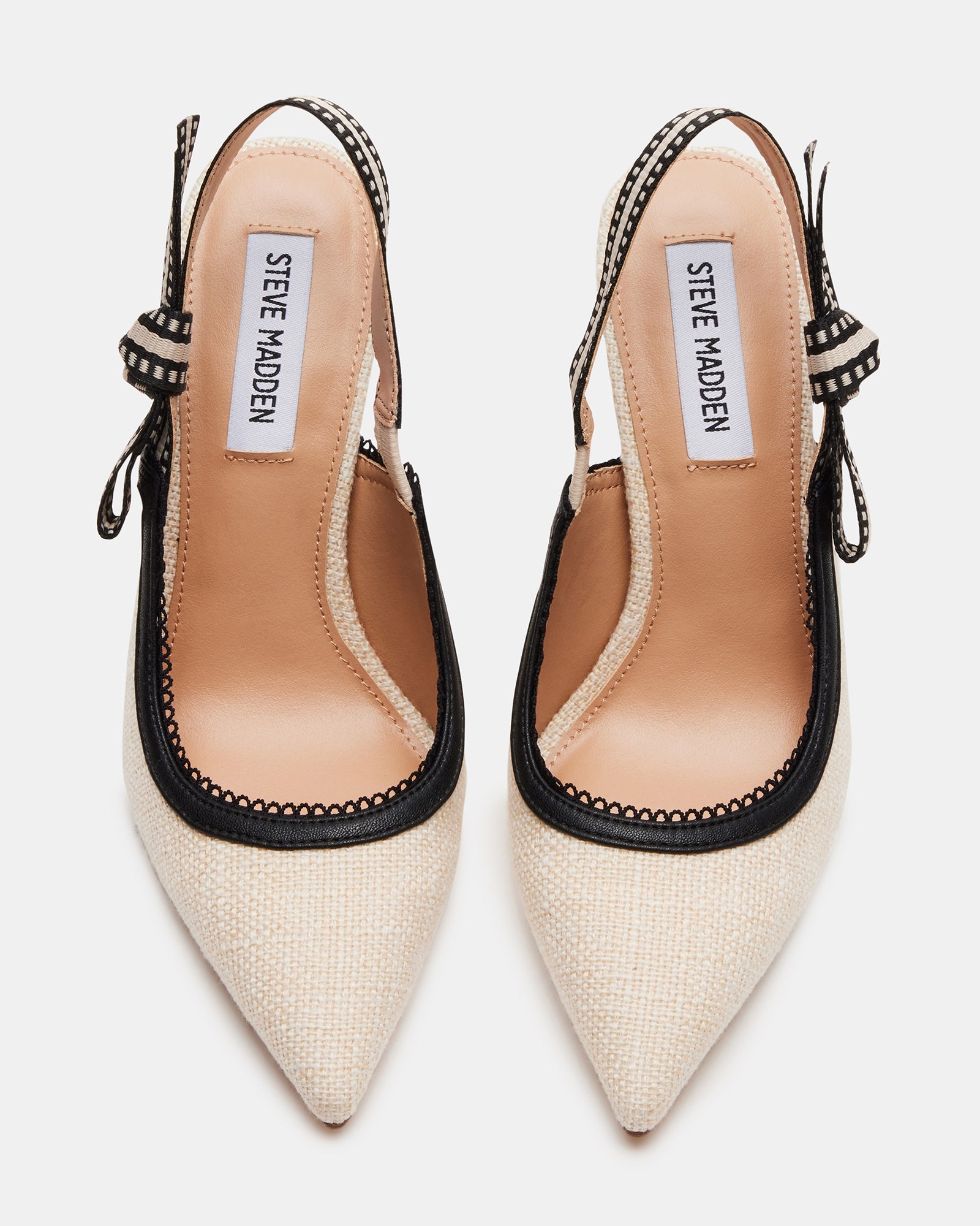 Top-down angle of pointed toe heels with ribbon detail near the slingback strap
