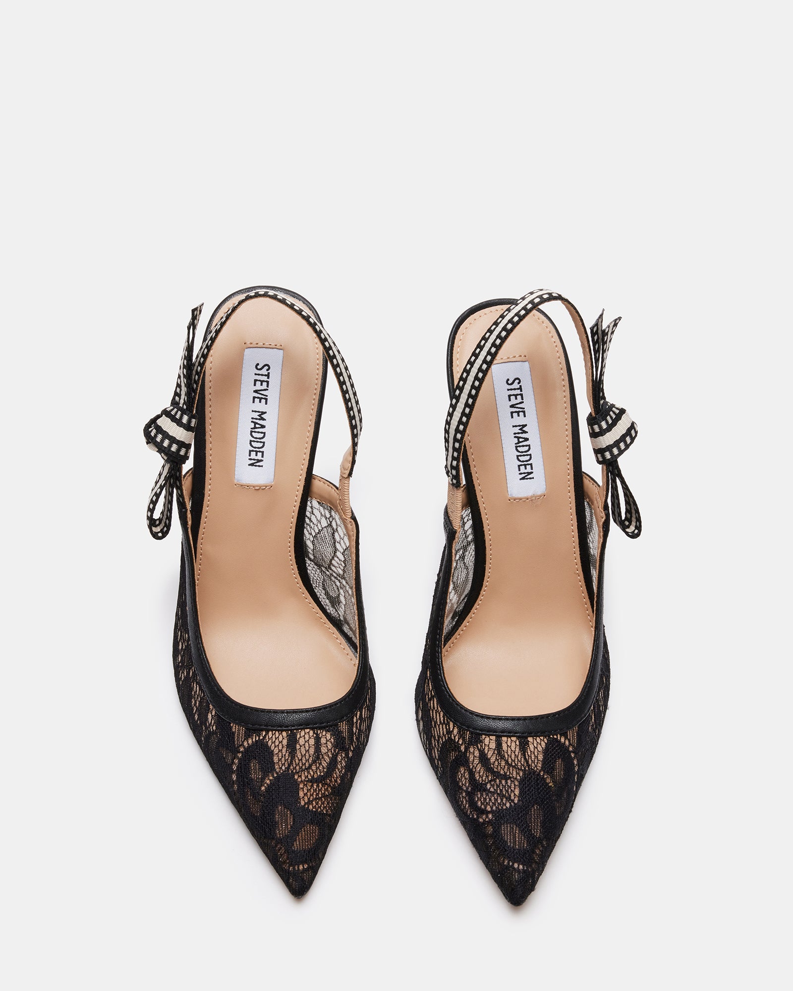 Lifestyle shot of stiletto slingback heels styled with evening wear in a NYC rooftop setting