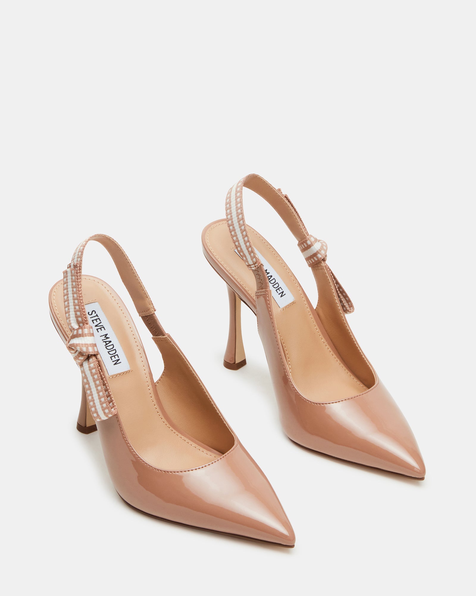 Styled shot of blush patent pumps with high heels in pink for elegant evening wear