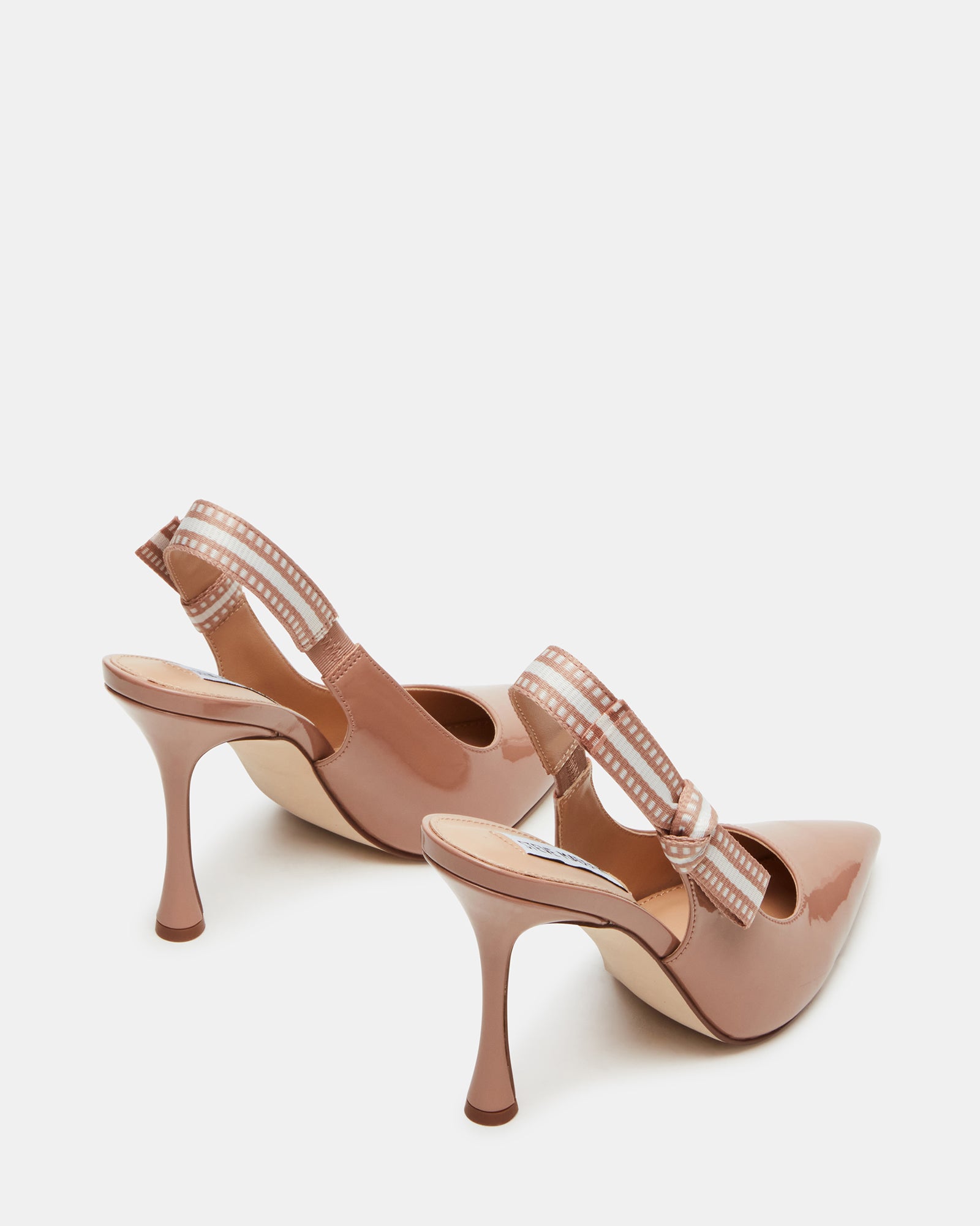 Styled shot of blush patent pumps with high heels in pink for elegant evening wear