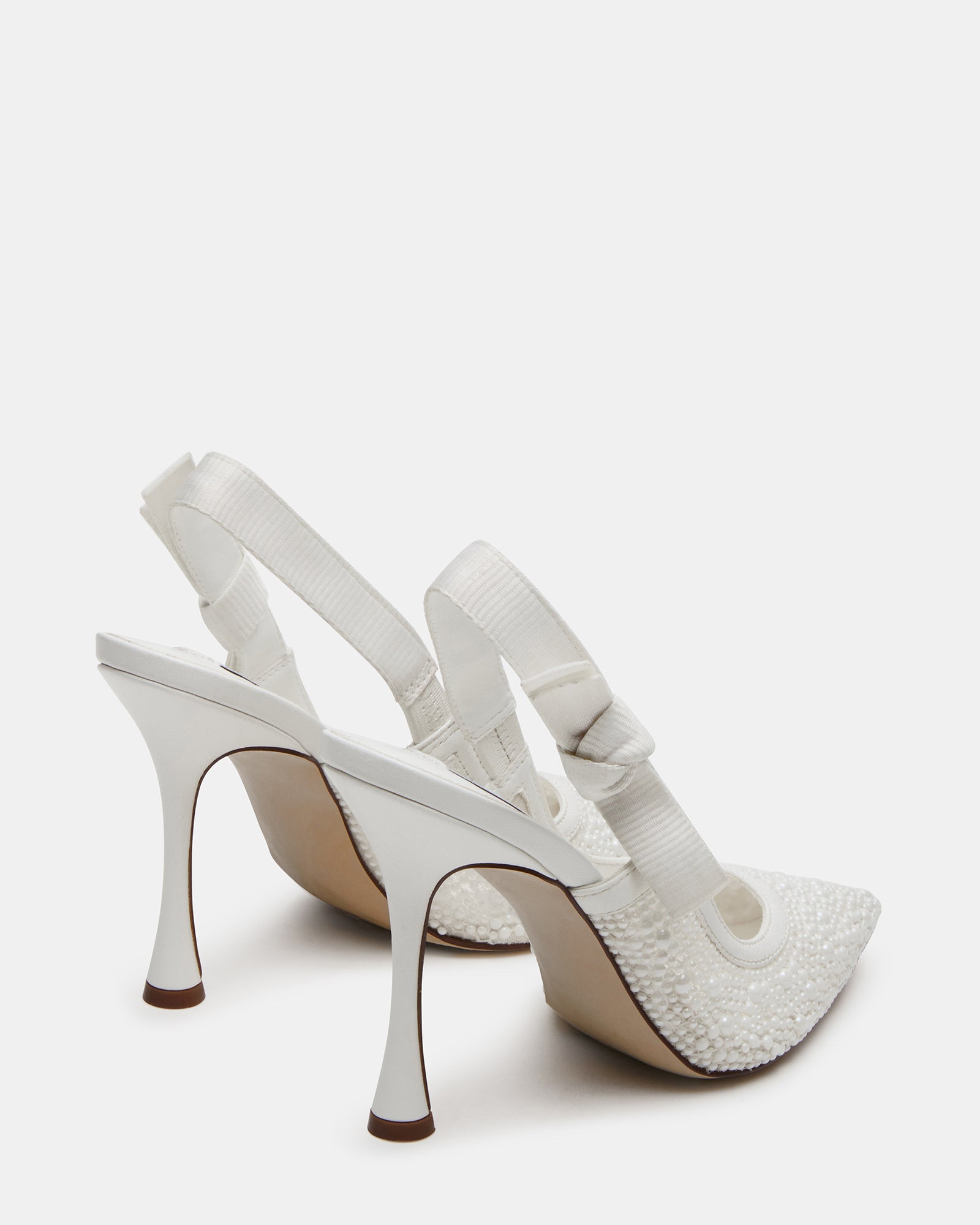 Close-up of the bow detail on the slingback strap of the white lace pumps.