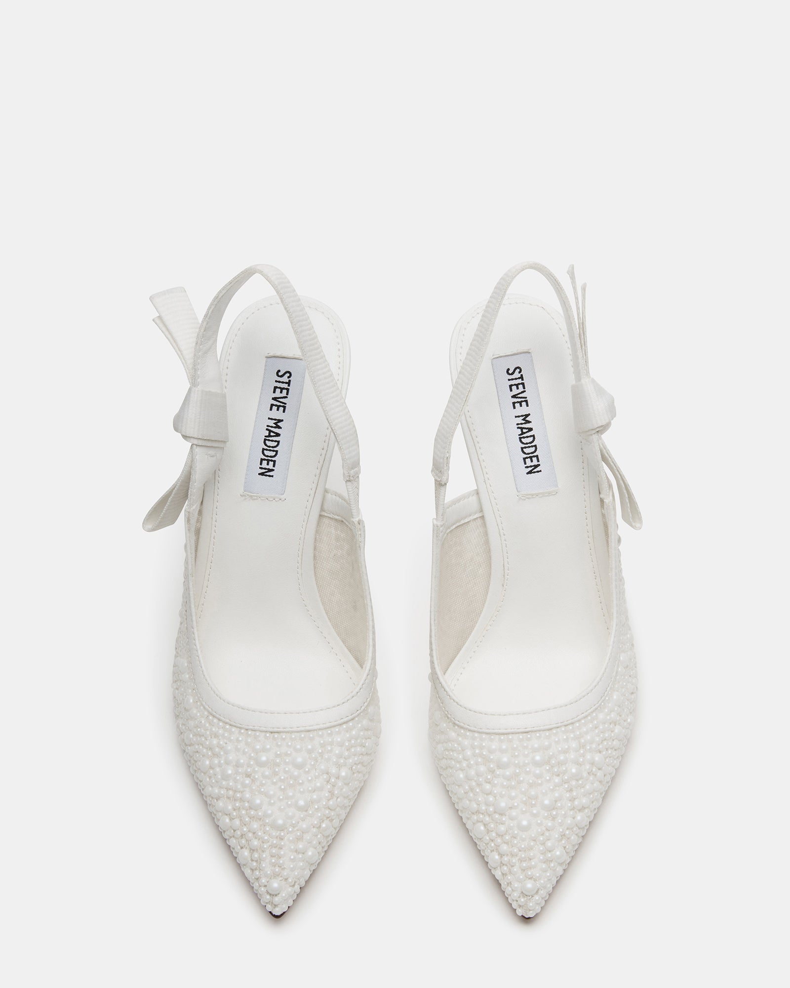 Side view of elegant white lace slingback heels on a model.