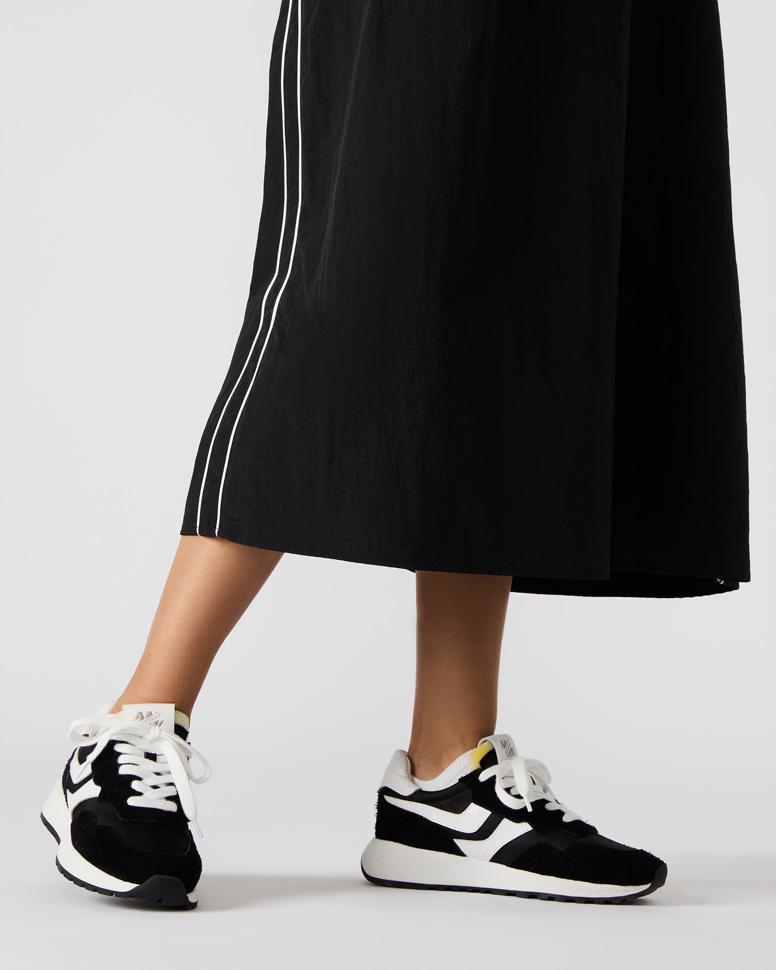 Woman wearing comfortable sneakers while walking in the city.