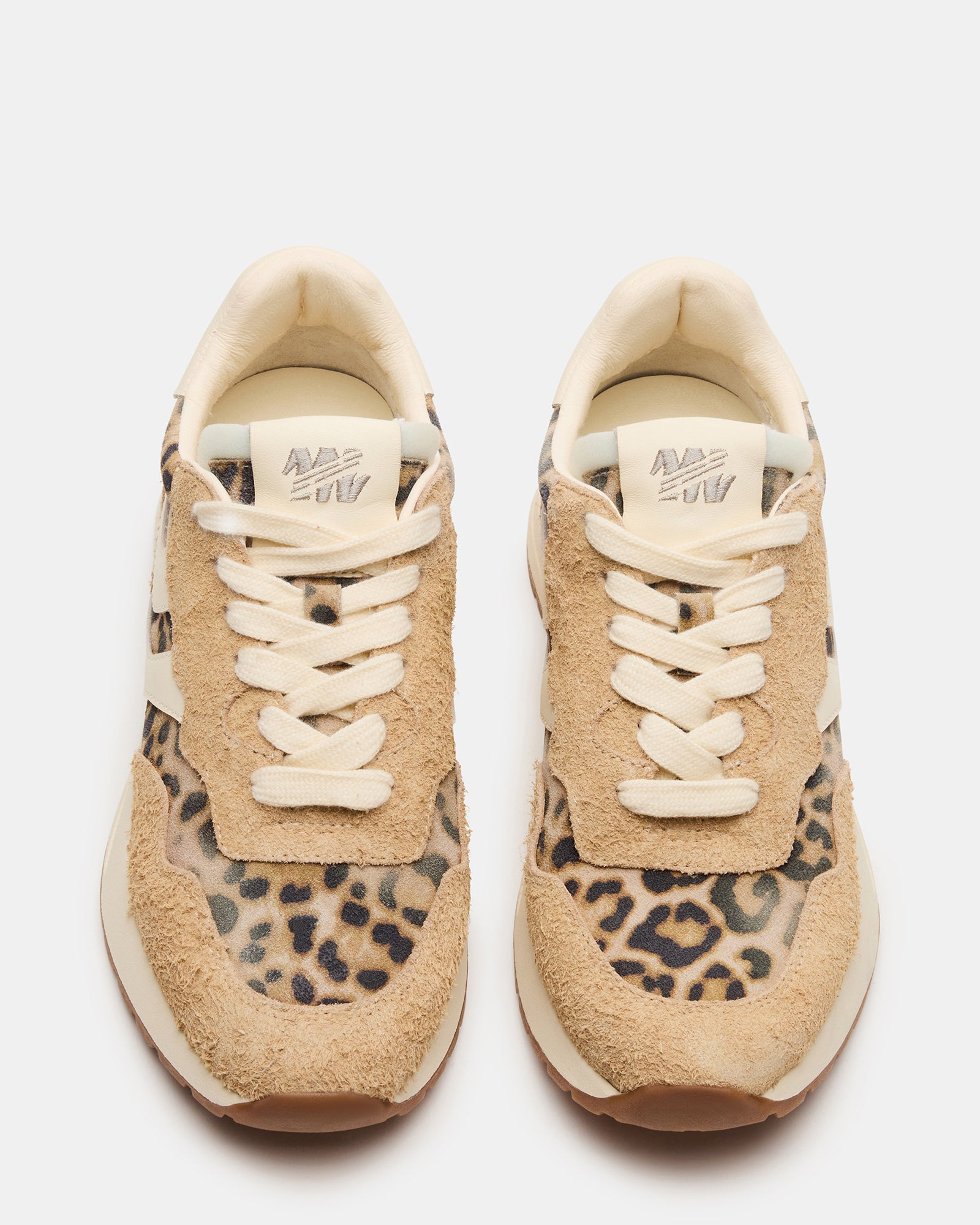 Side view of Bottega leopard lace-up sneakers on a city street.