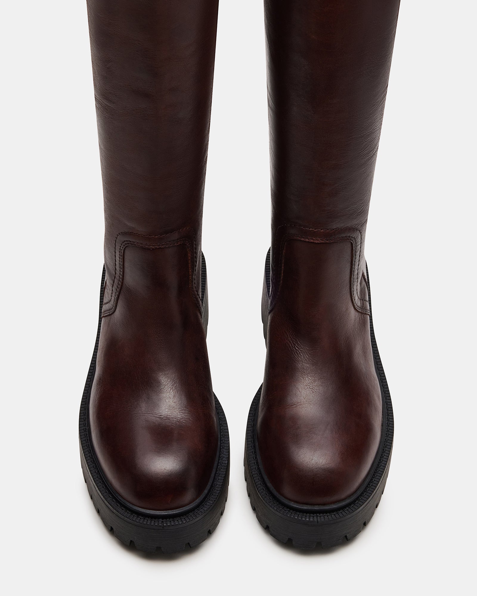 Side view of cognac leather boots showing platform sole and buckle hardware