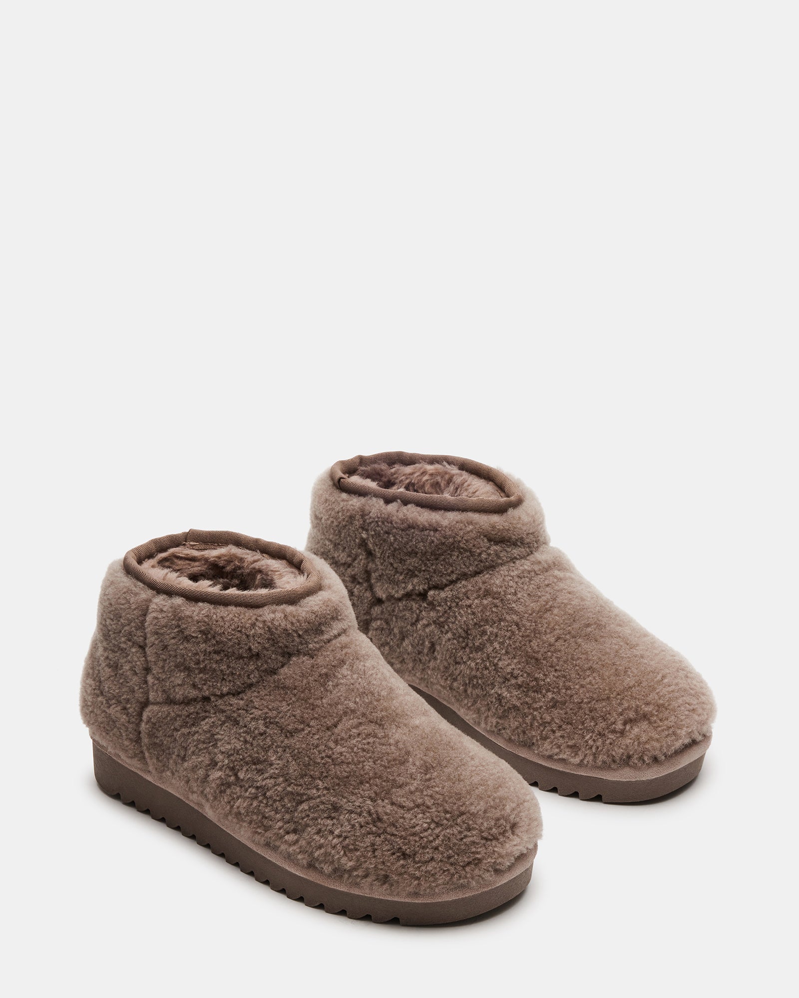 Top-down shot showing faux shearling interior of womens winter boots