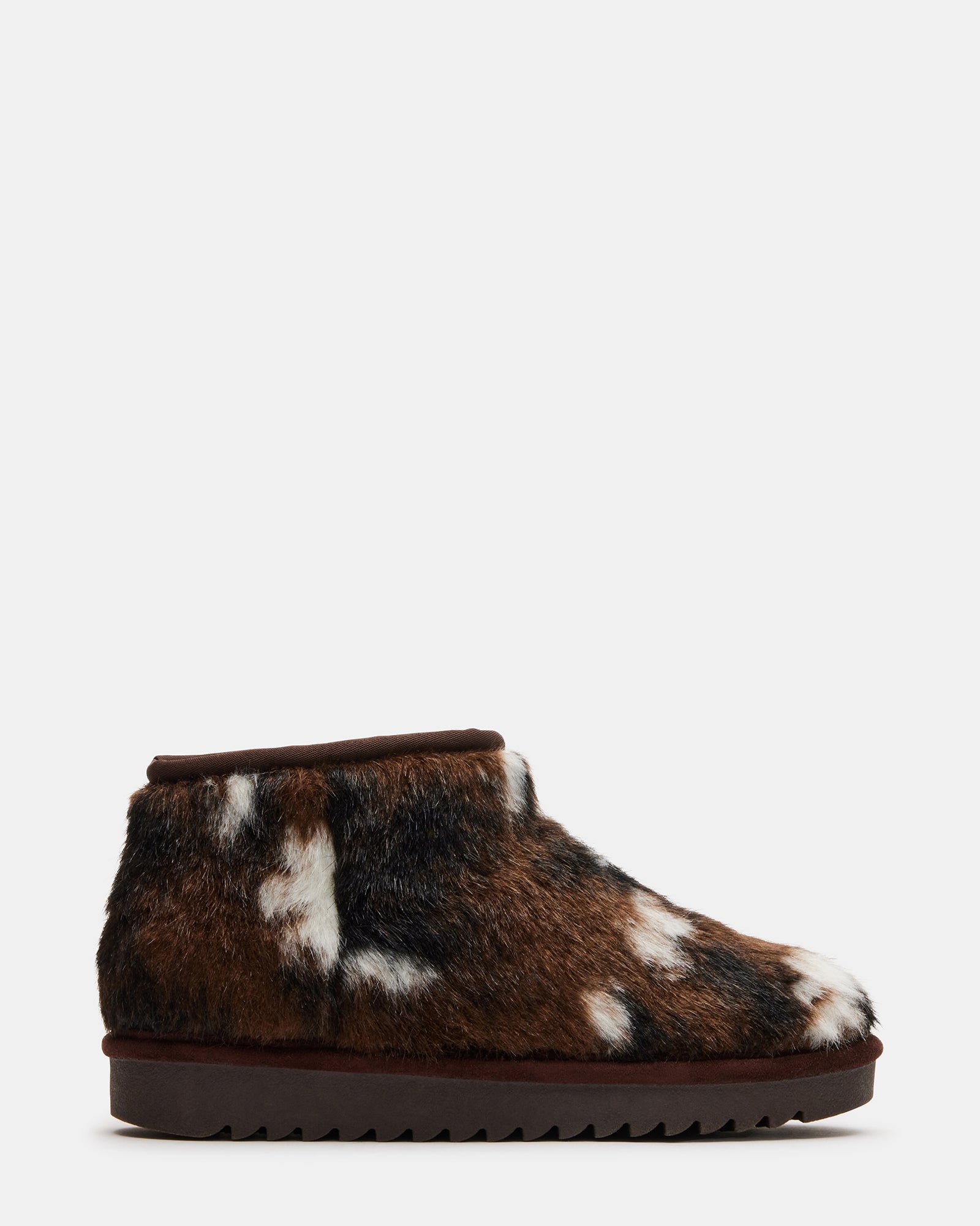 Side view of faux fur boot showing slip-on design and cozy lining