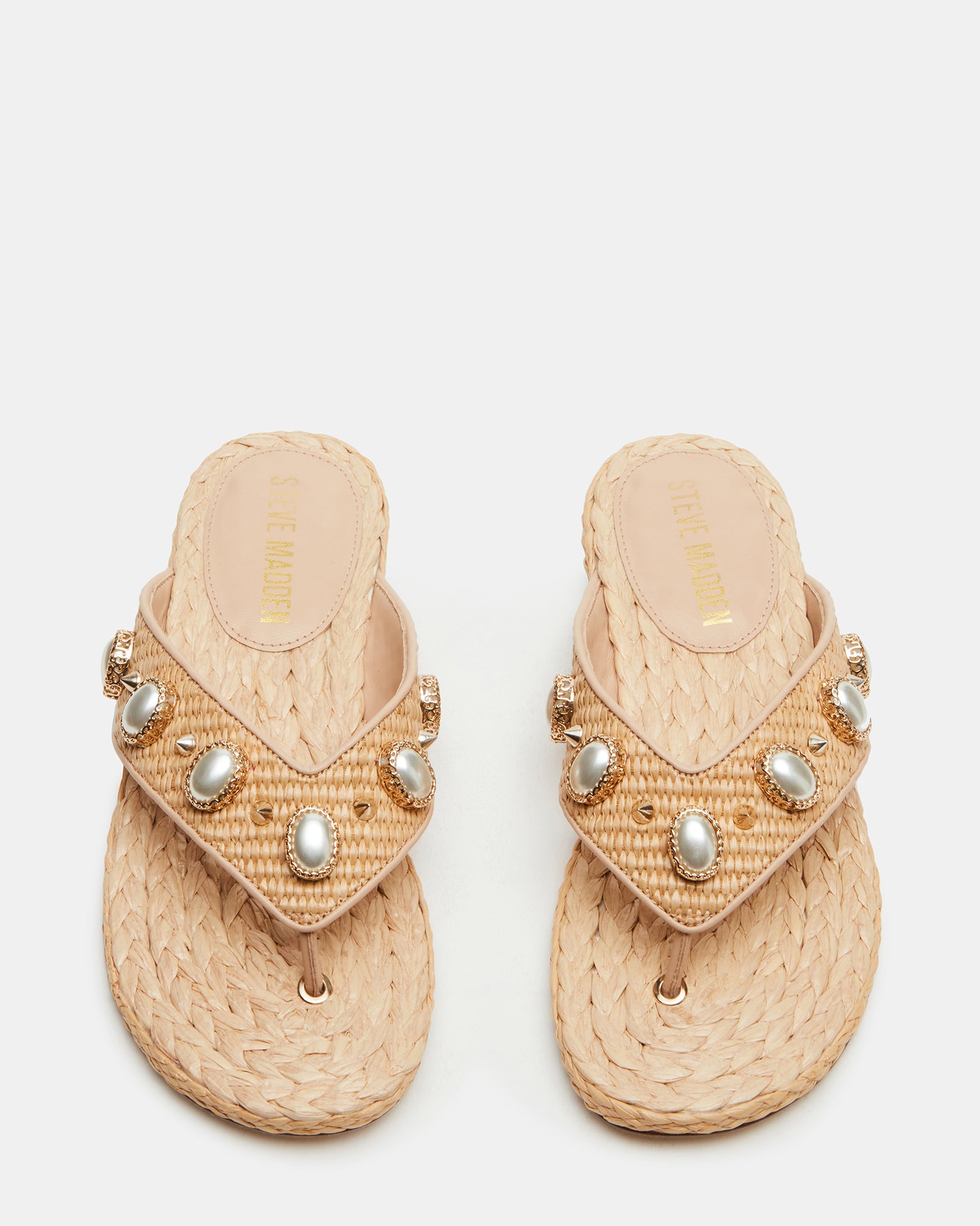 Close-up of pearl embellishments on raffia heeled sandals