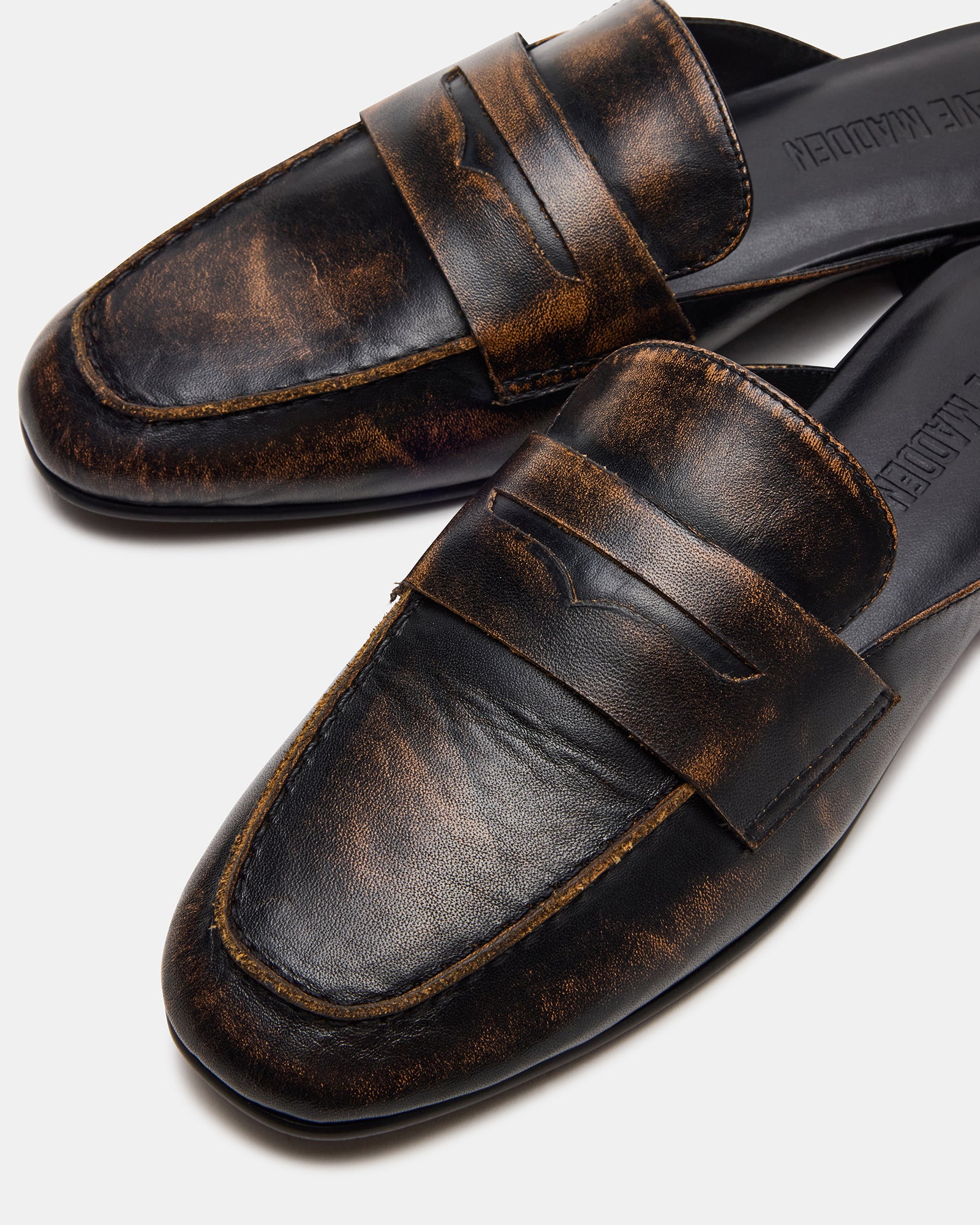 Caleb mules worn with casual attire, highlighting versatility.