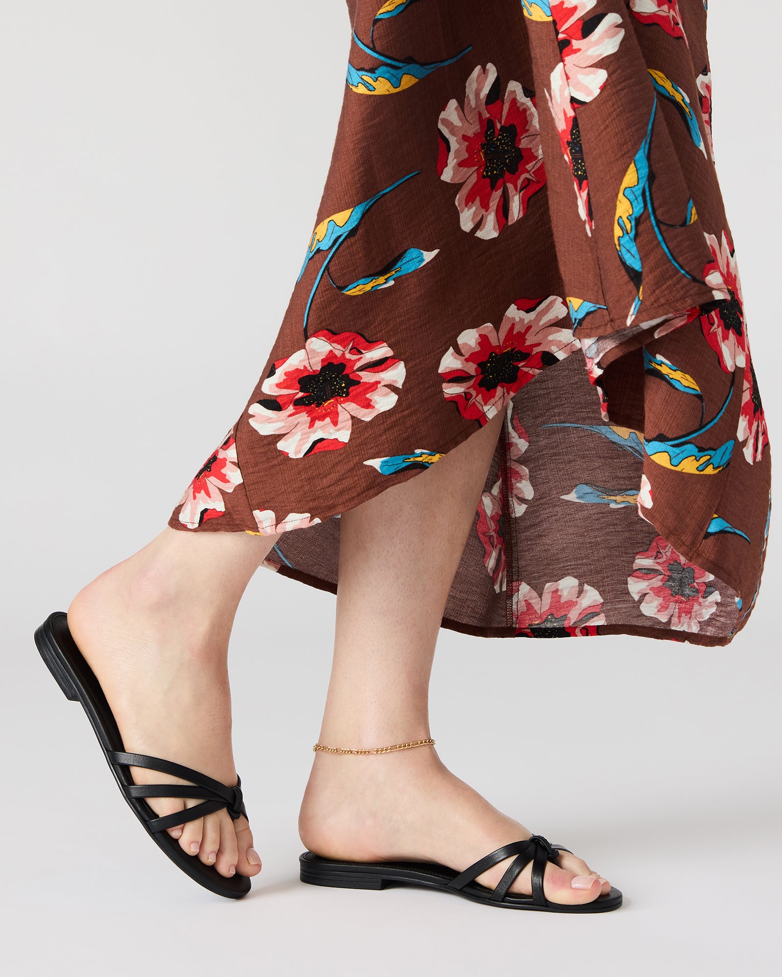 Close-up of Calissi black leather sandals showcasing the luxurious material.