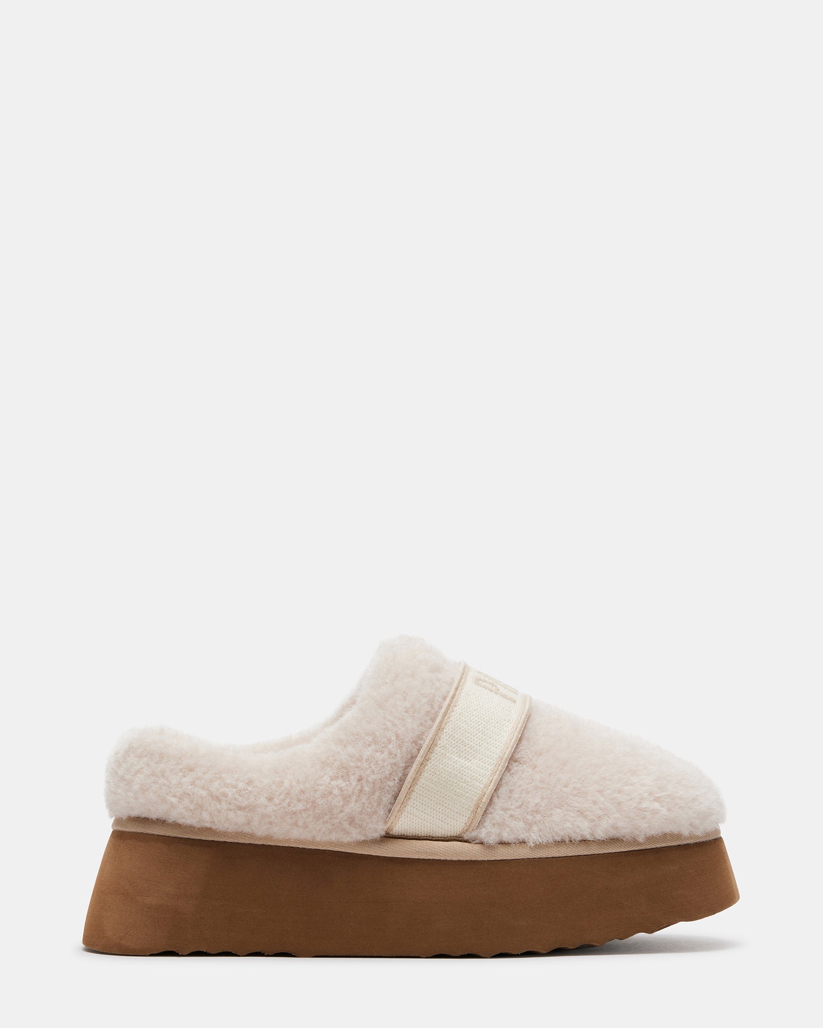 Flatform fuzzy mule slippers worn indoors with cozy socks