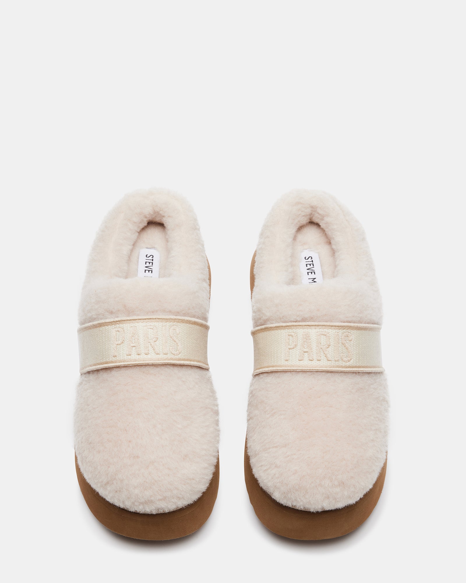 Flatform fuzzy mule slippers worn indoors with cozy socks