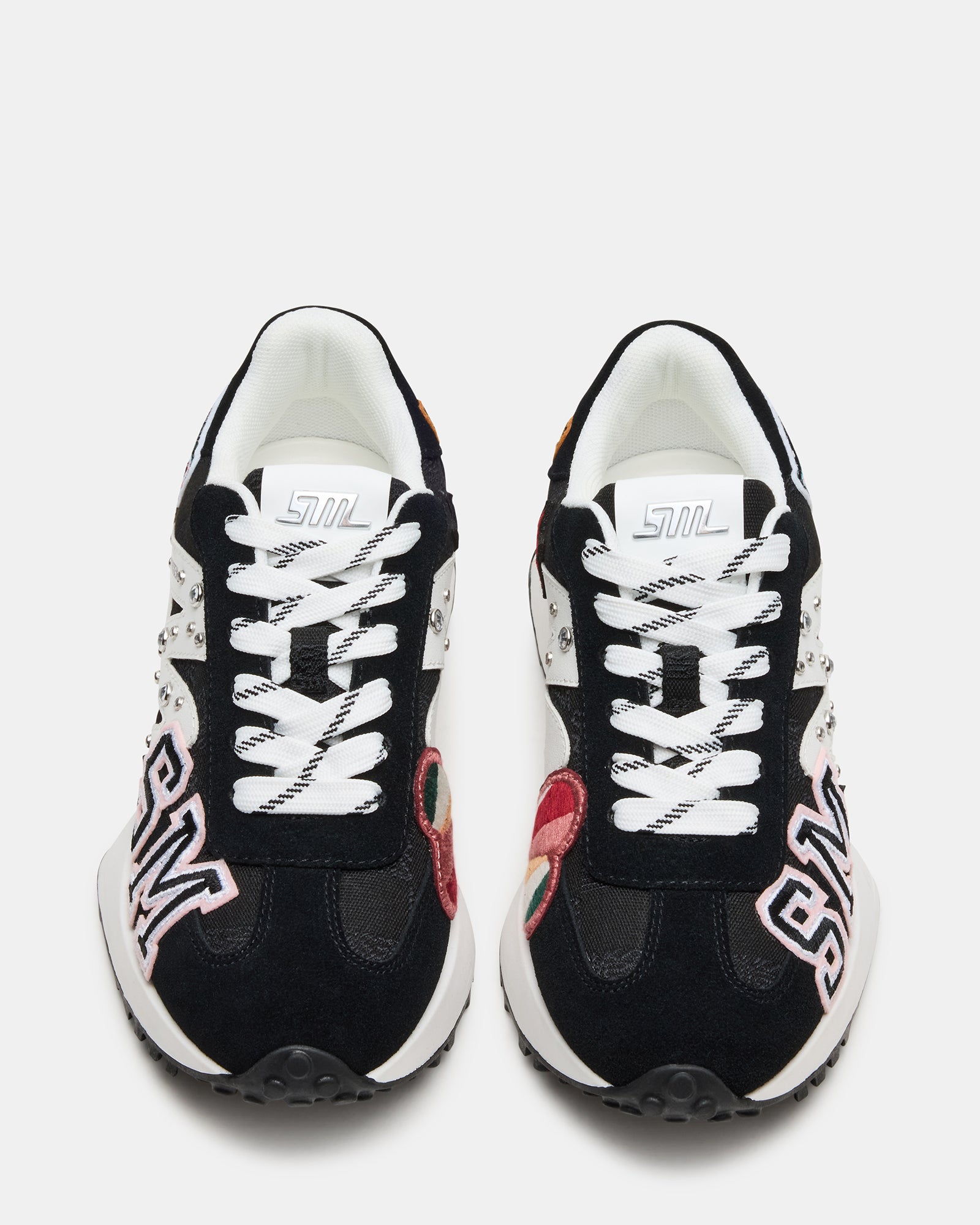 Front angle of black and white sneakers showing the textured heel detail