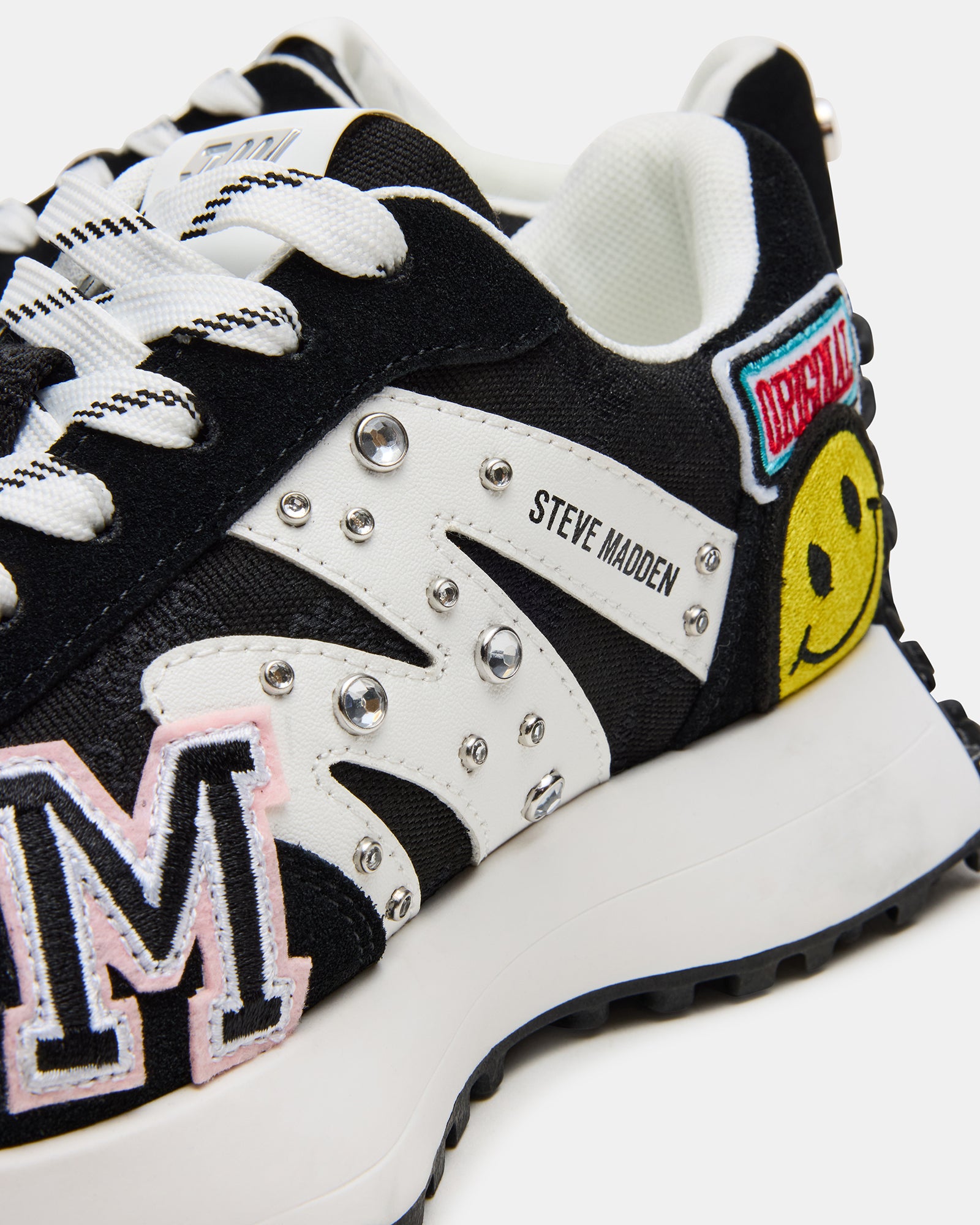 Top view of white platform sneakers laced up on foot in casual urban outfit
