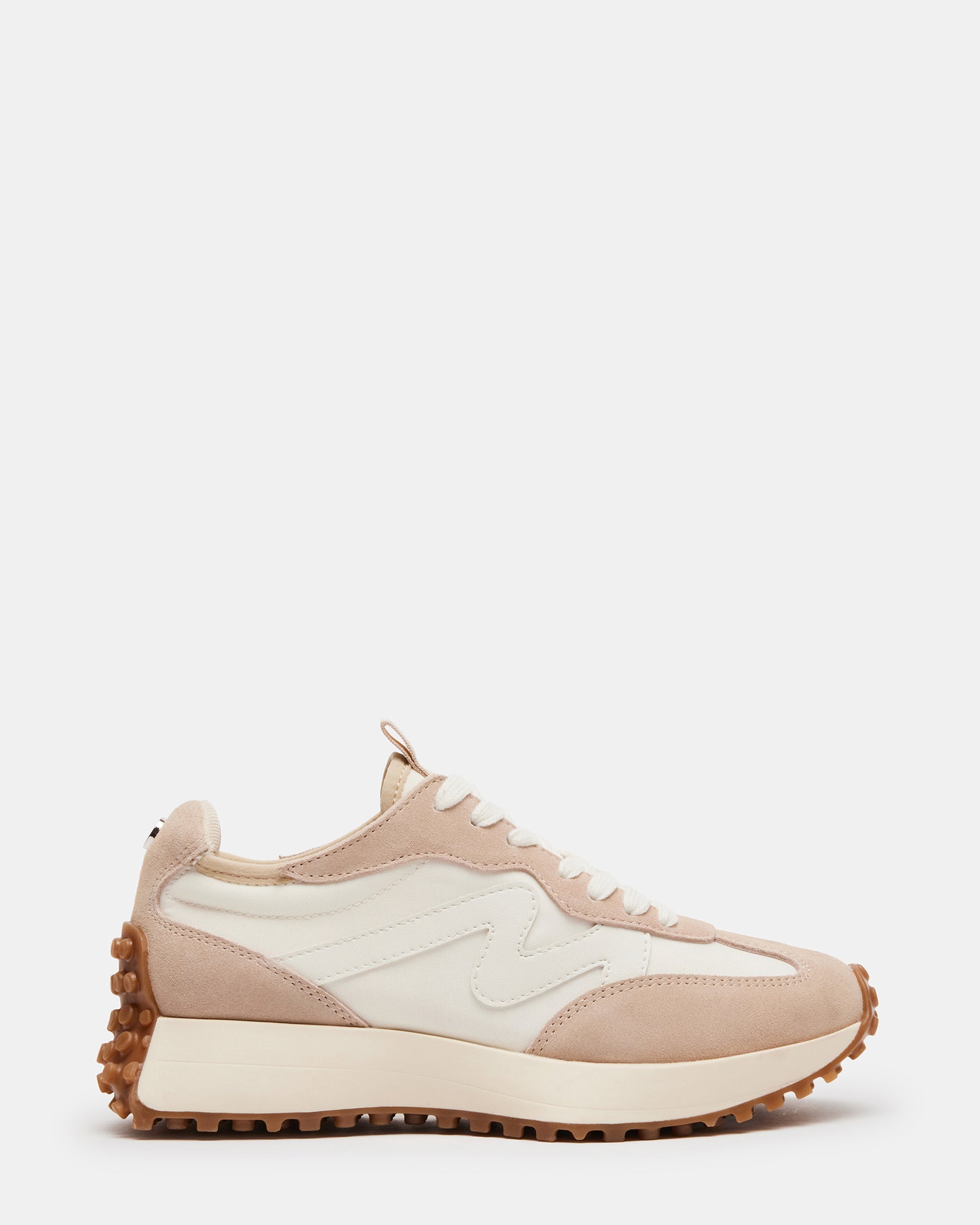 Front view of beige platform sneakers on a wooden surface