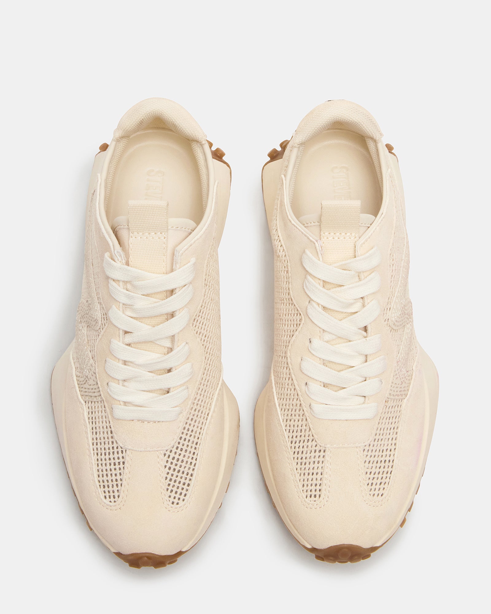 Front angle of white platform sneakers with textured sole and lace-up design