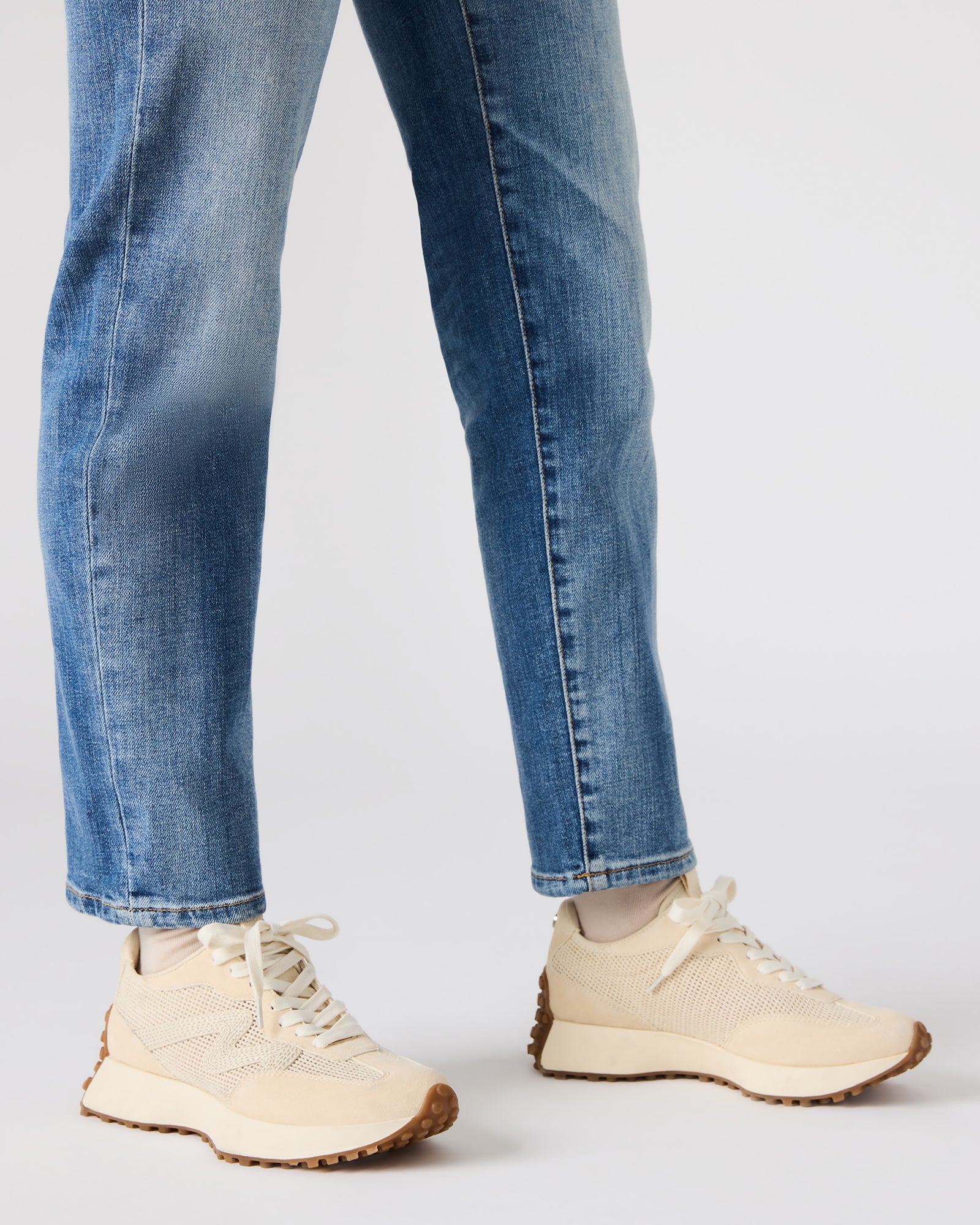 Front angle of white platform sneakers with textured sole and lace-up design