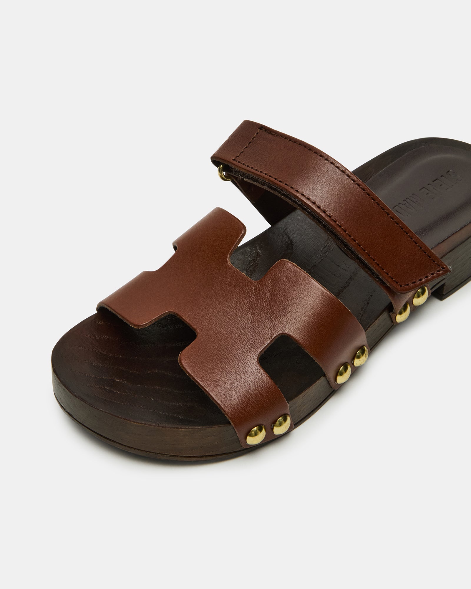 Model wearing brown sandals for a casual look