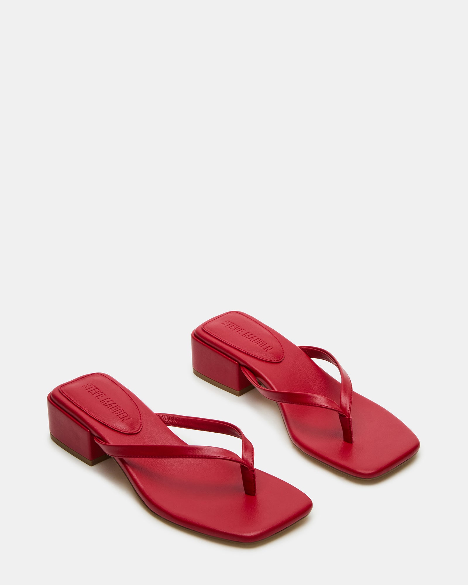 Close-up of the vegan leather upper of Caribbean Red sandals.