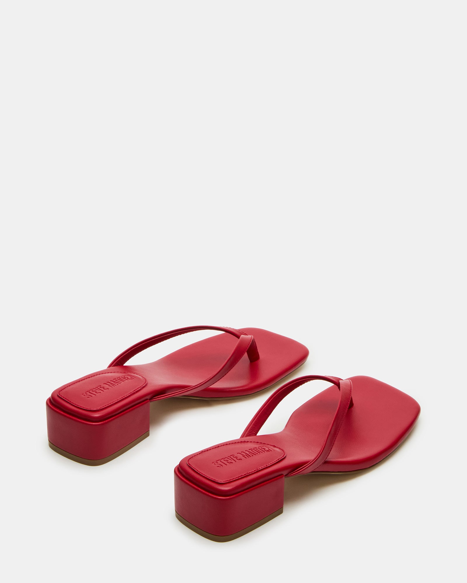 Close-up of the vegan leather upper of Caribbean Red sandals.