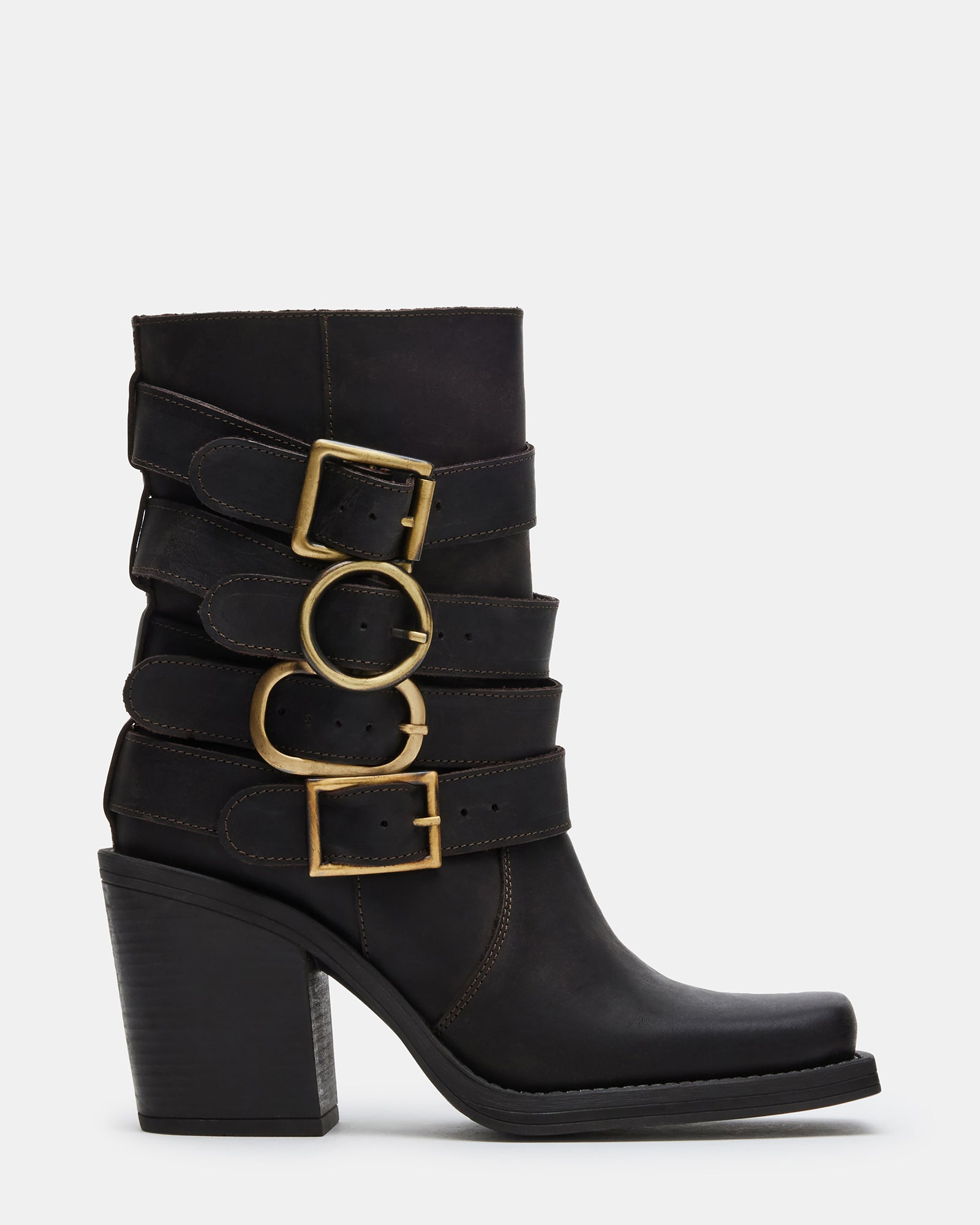 Side view of Carlina brown leather ankle boots on a wooden floor
