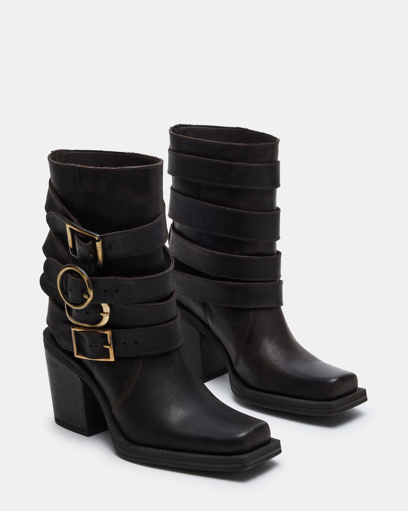 Outfit pairing featuring knee-high brown leather boots in urban setting