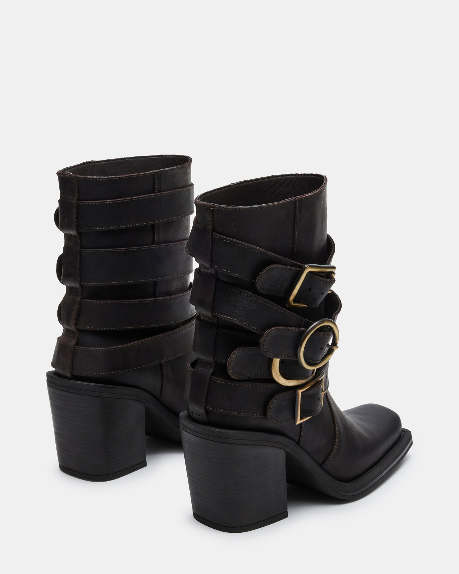 Outfit pairing featuring knee-high brown leather boots in urban setting