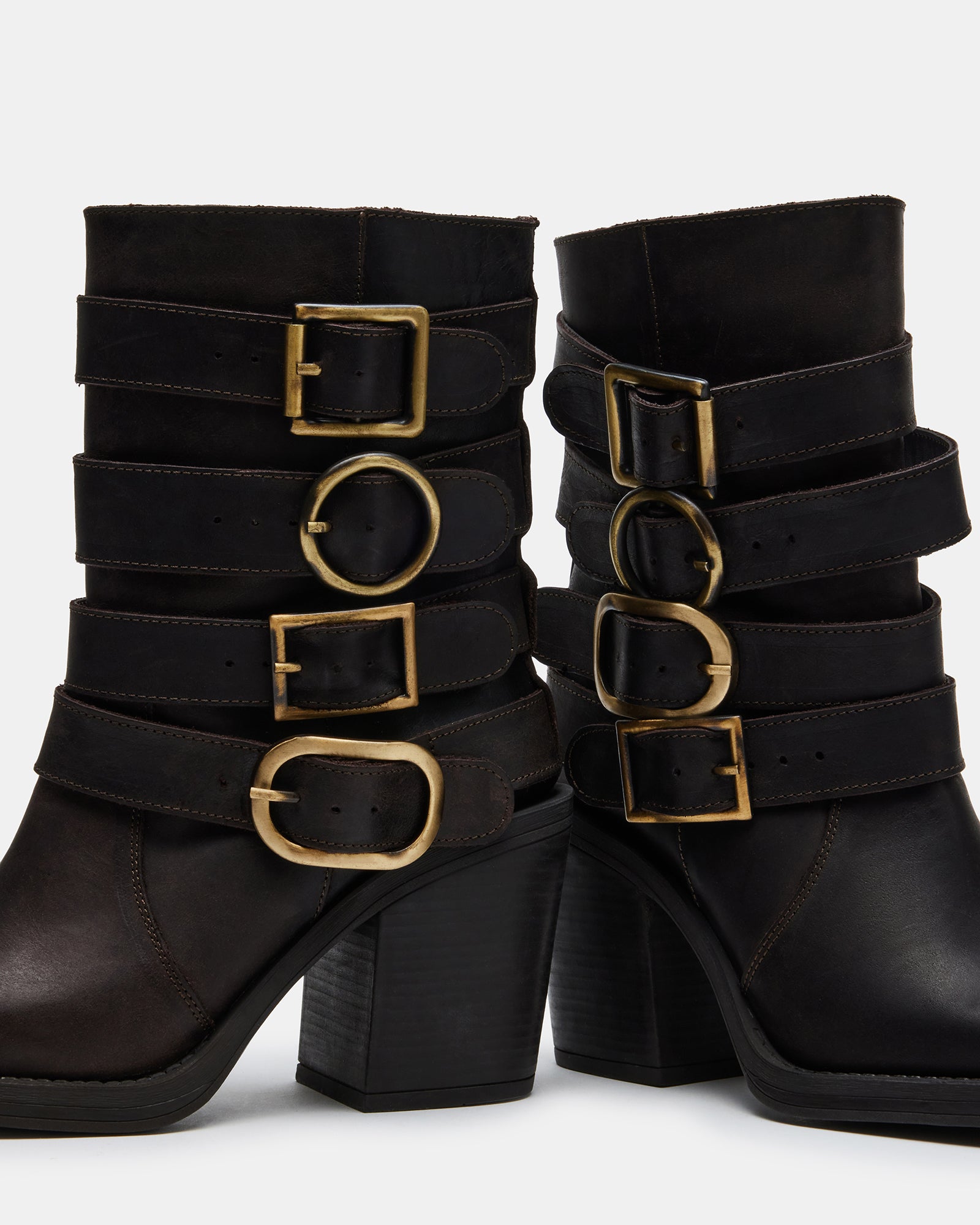 Side view of Carlina brown leather ankle boots on a wooden floor