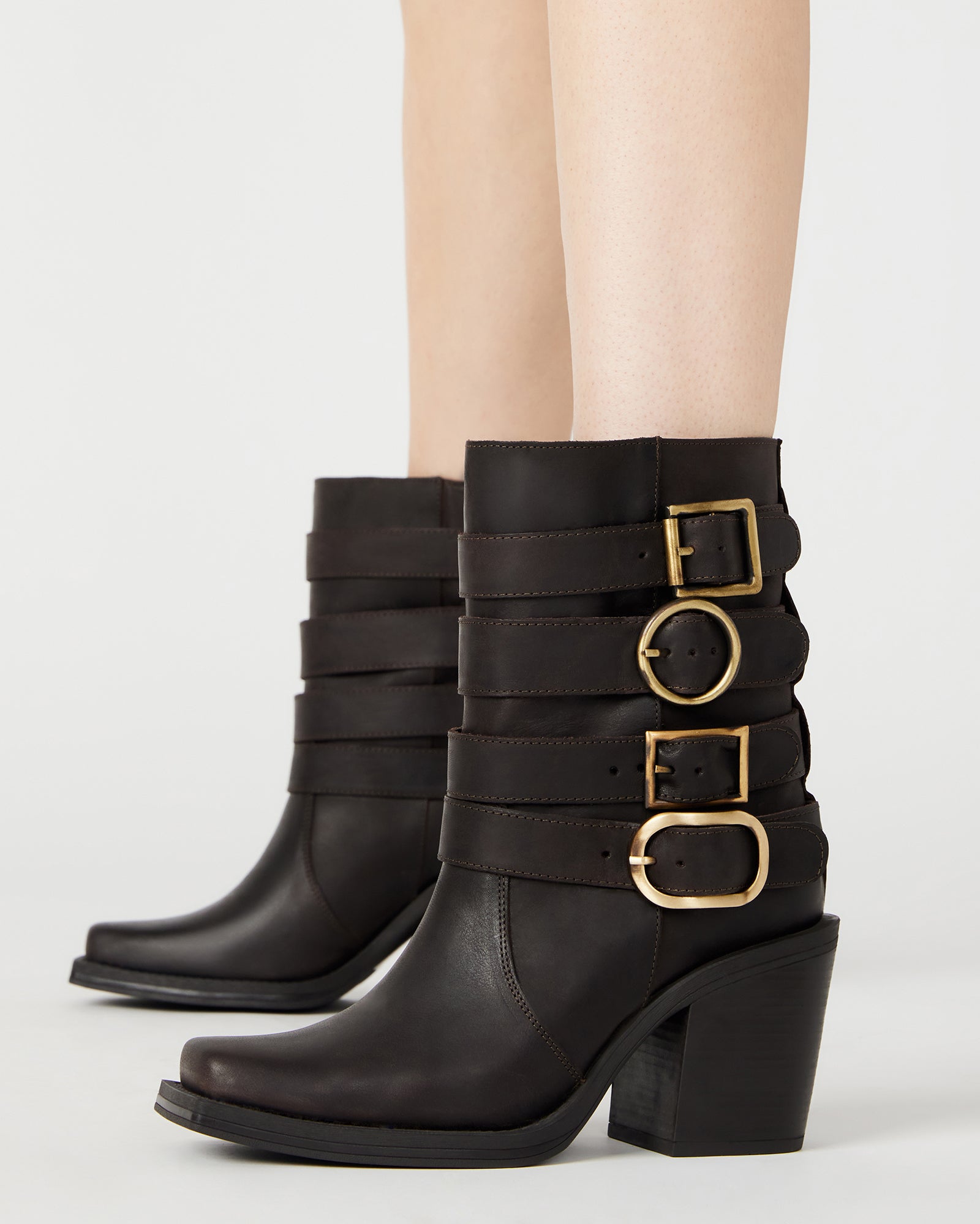 Close-up of distressed detailing on womens brown leather boots