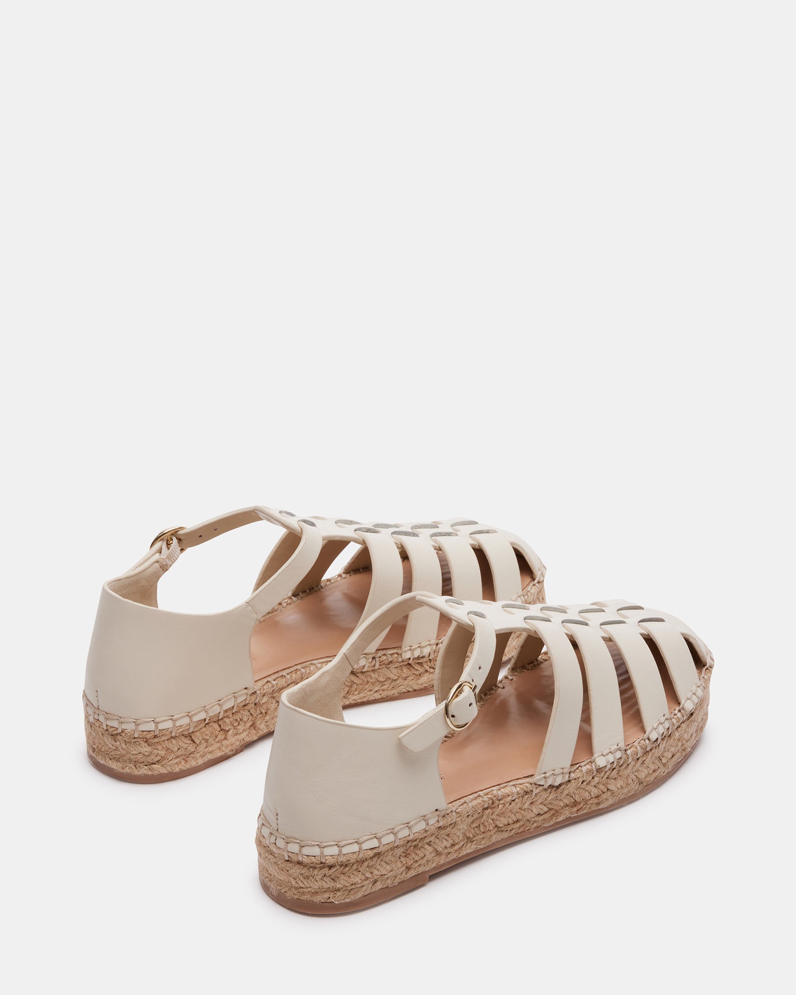 Close-up of the leather upper and flat sole of espadrilles for women