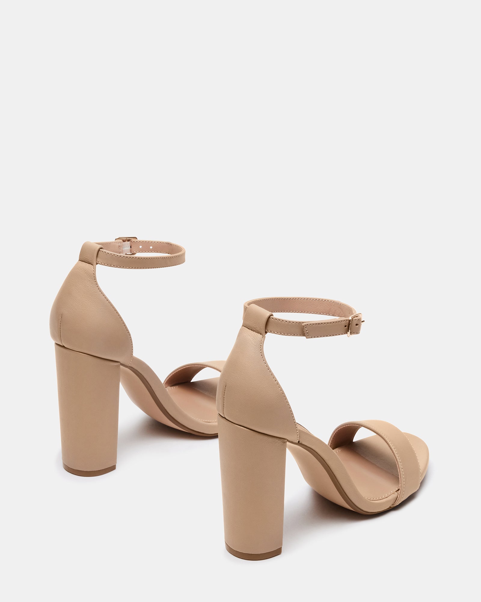 Carrson blush leather block heel sandals styled with skinny jeans for a chic, casual look.