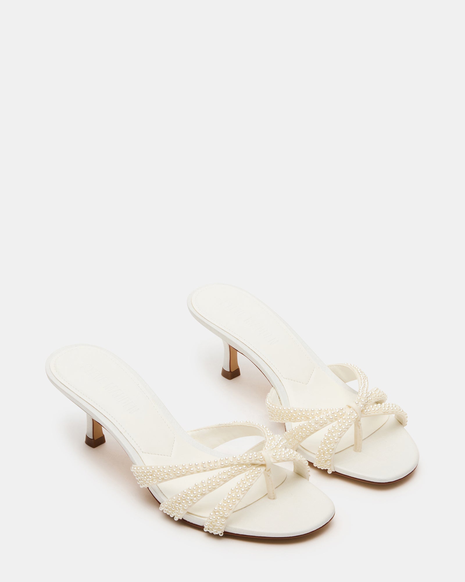 Close-up of the textile upper with intricate ornaments on these kitten heel mules shoes.