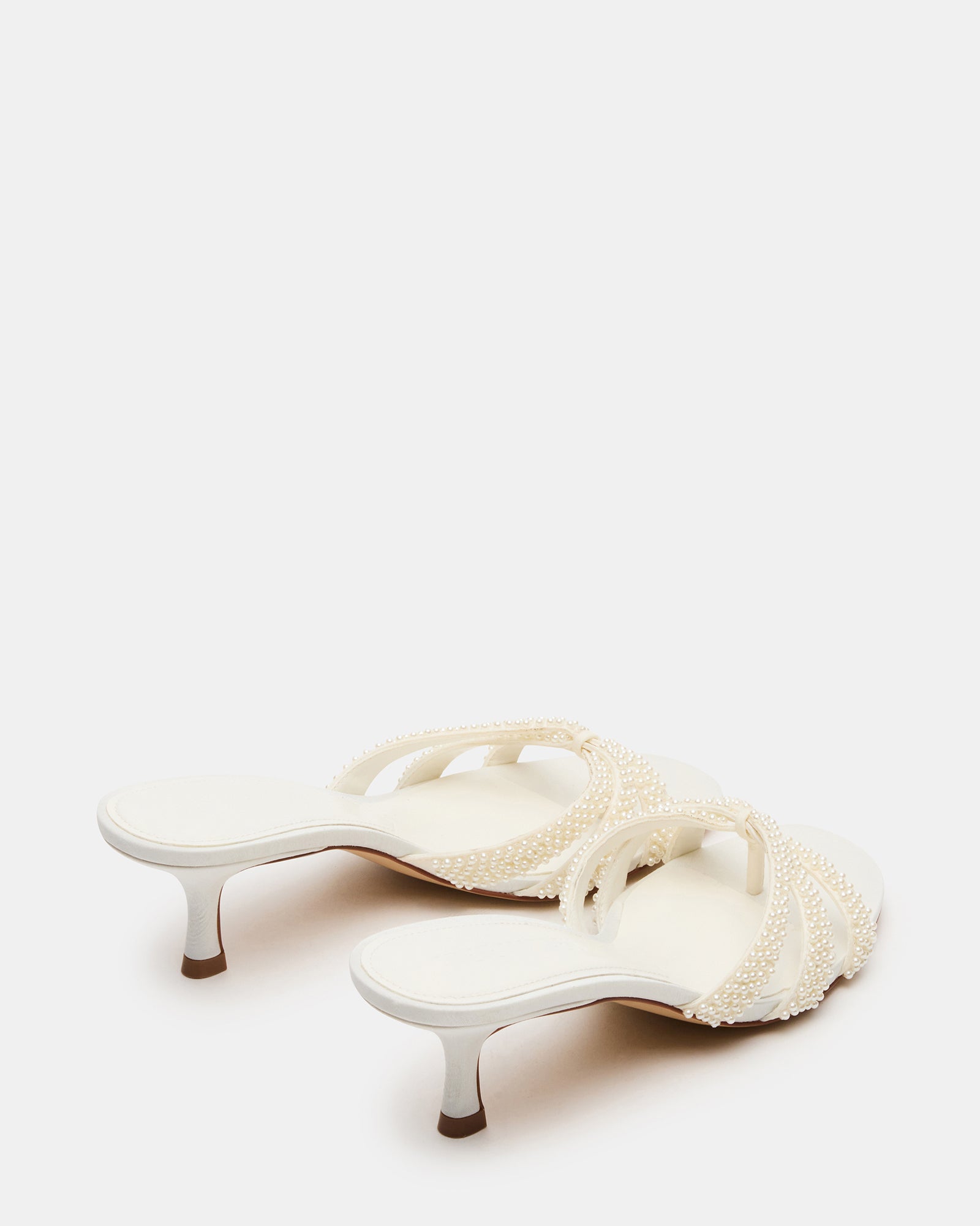 Close-up of the textile upper with intricate ornaments on these kitten heel mules shoes.