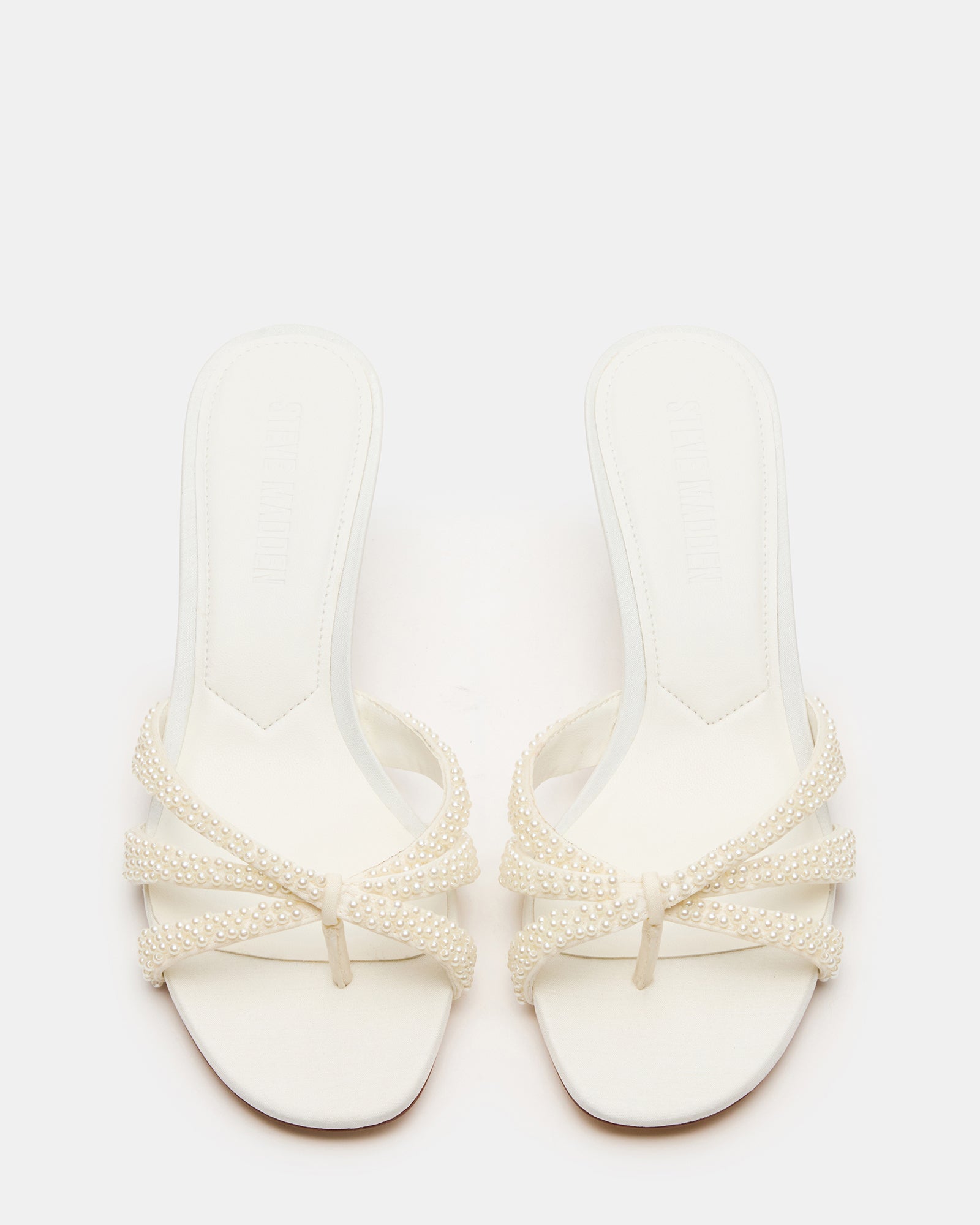 Cary Pearl Ivory mules heels shown from the side, highlighting the open-toe design.