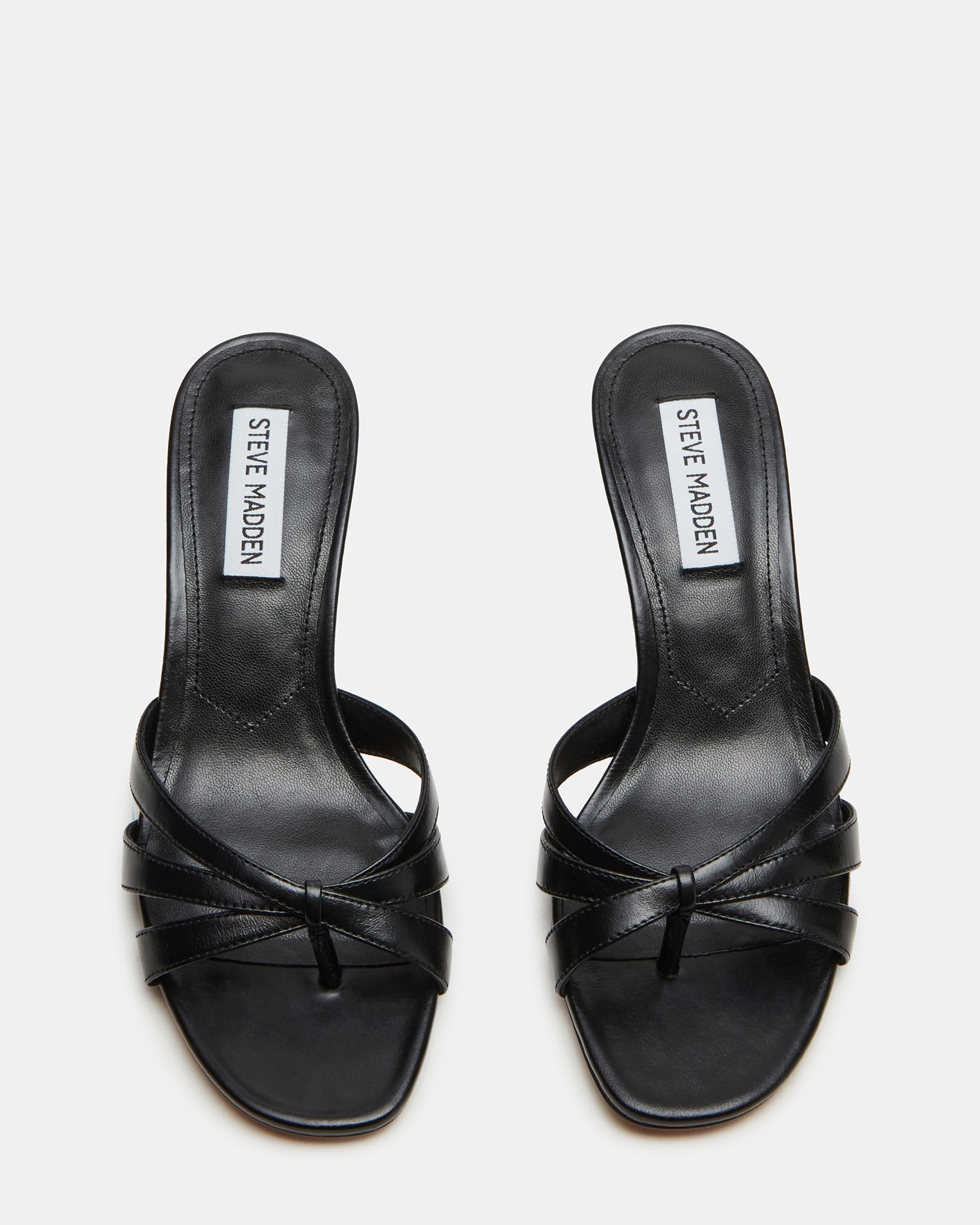 Top-down angle showing open toe and leather upper of black mule slippers for women