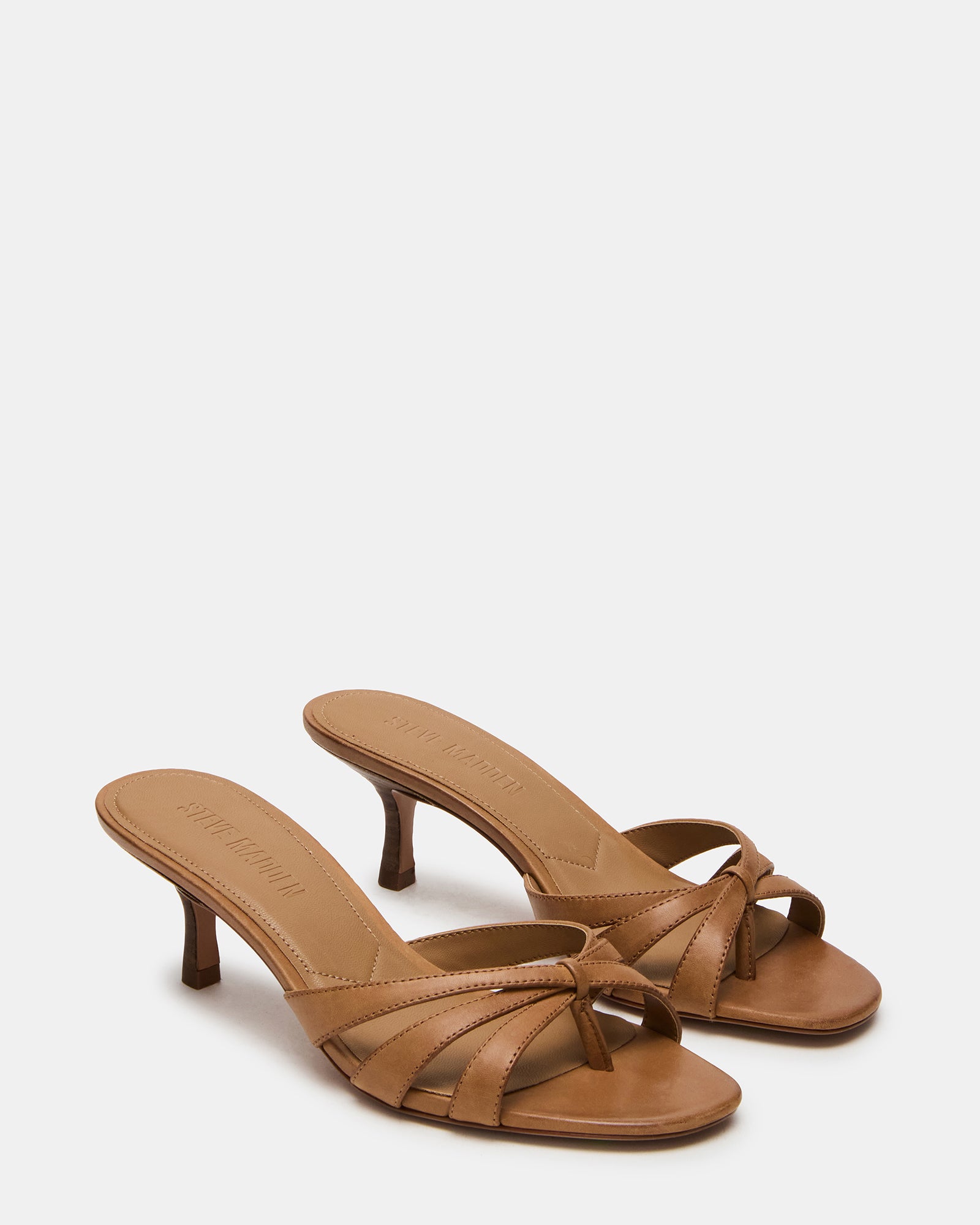 Side view of the black leather mules highlighting the 2.75-inch heel.